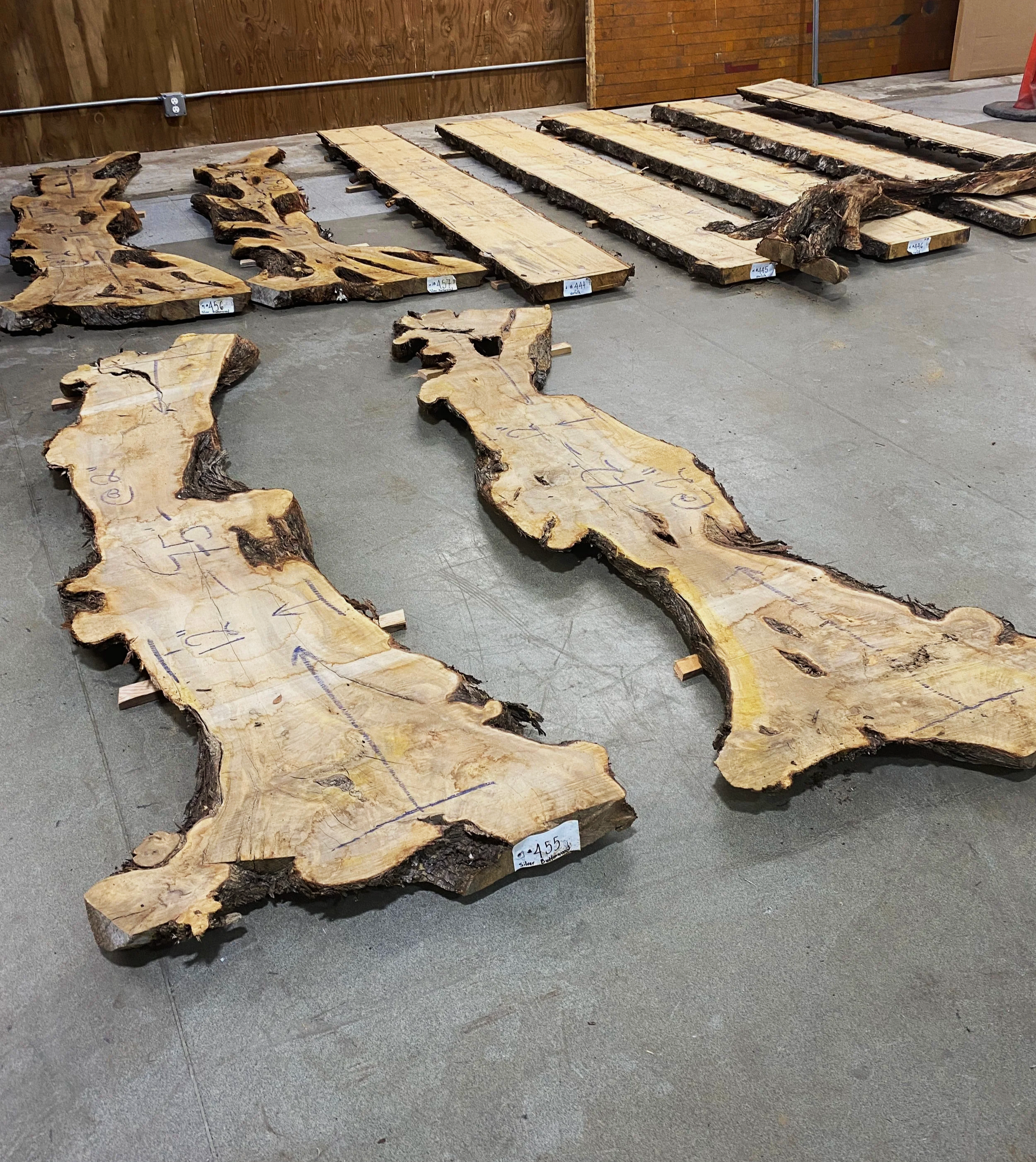 Two wood slabs laying on the floor at Re-use Hawai‘i.
