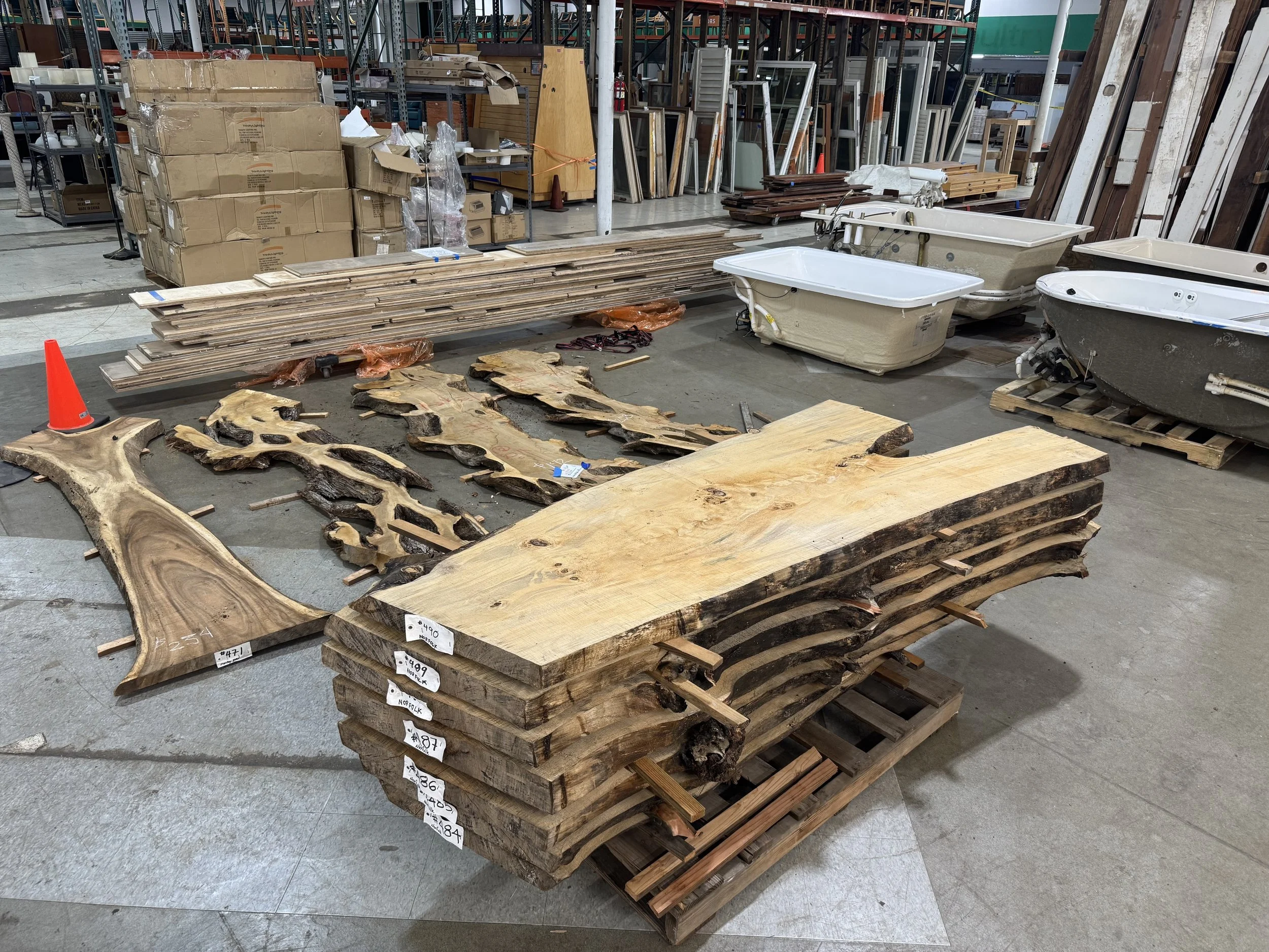 A stack of wood slabs for sale on the floor at Re-use Hawai‘i.