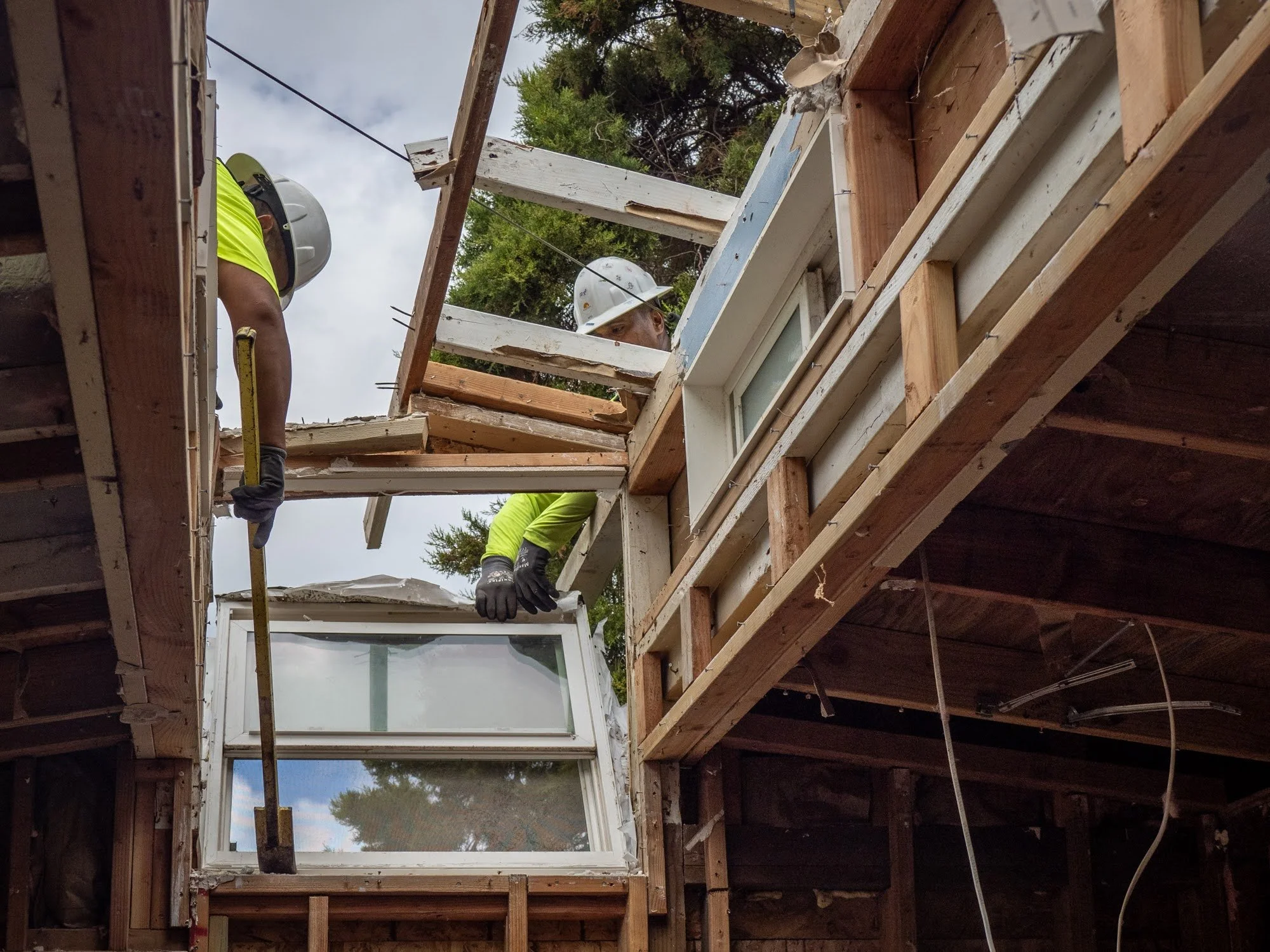 Close-up image of a home being deconstructed by hand.