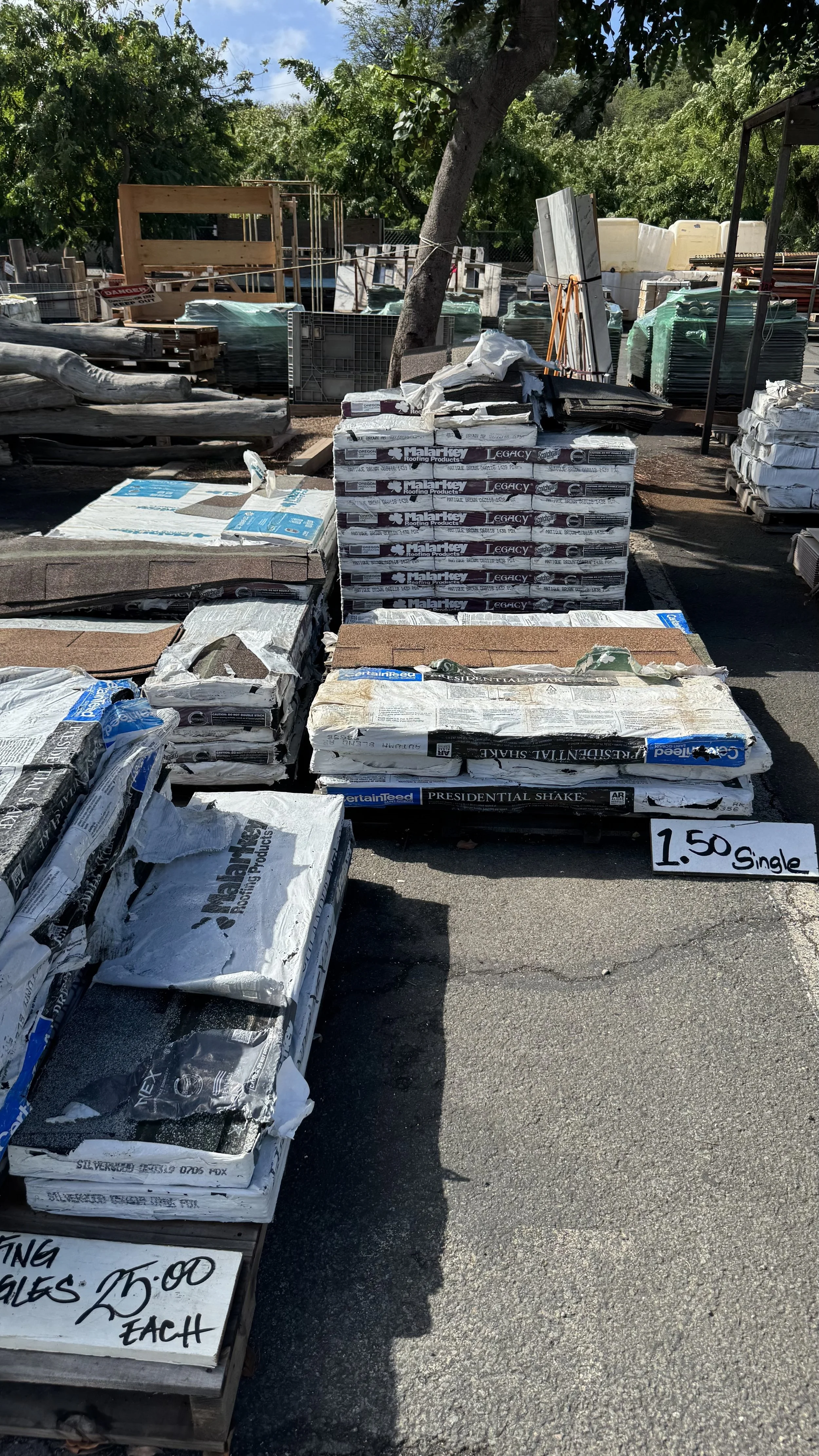 A photo of new and unused packages of roofing in the Lumberyard at Re-use Hawai‘i.