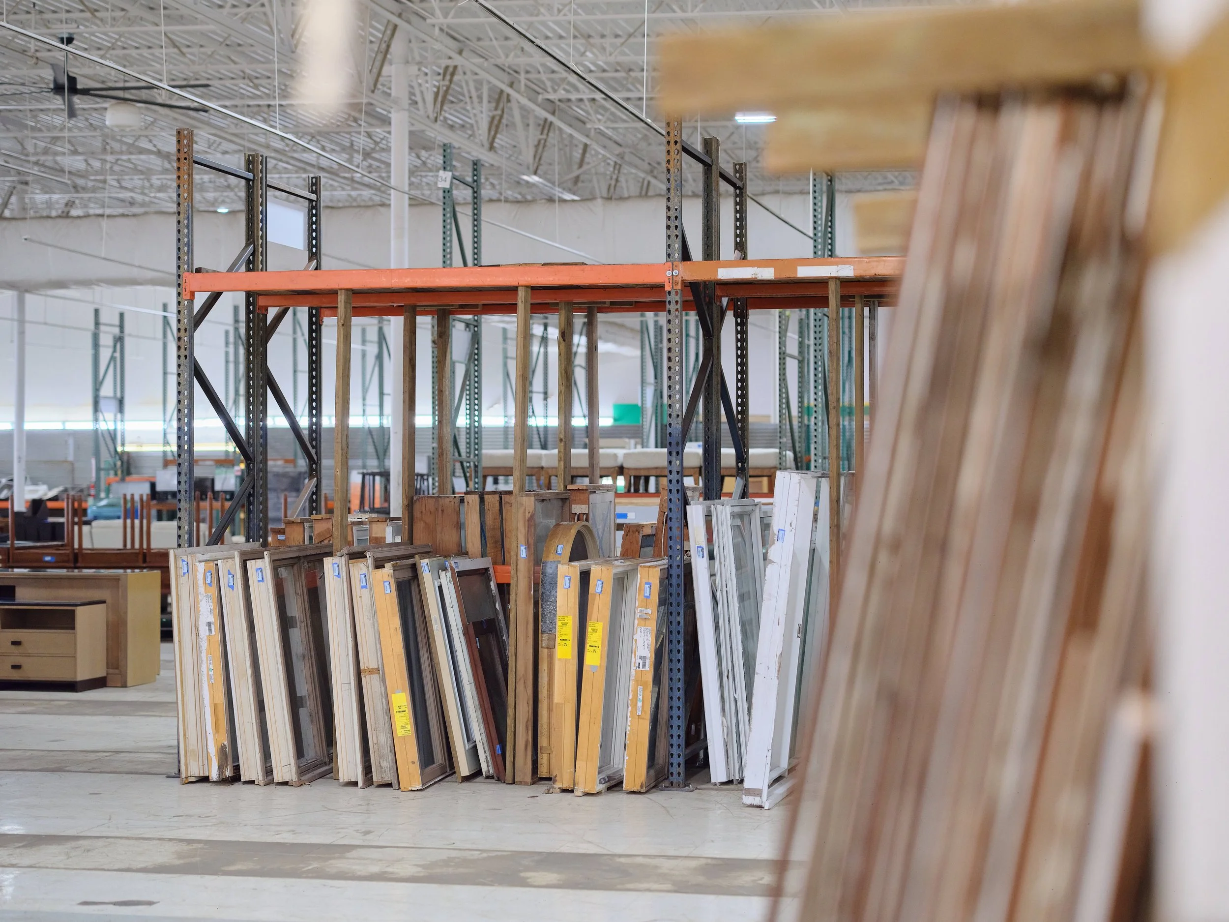 A creative photo of the windows and doors for sale at the Re-use Hawai‘i store.