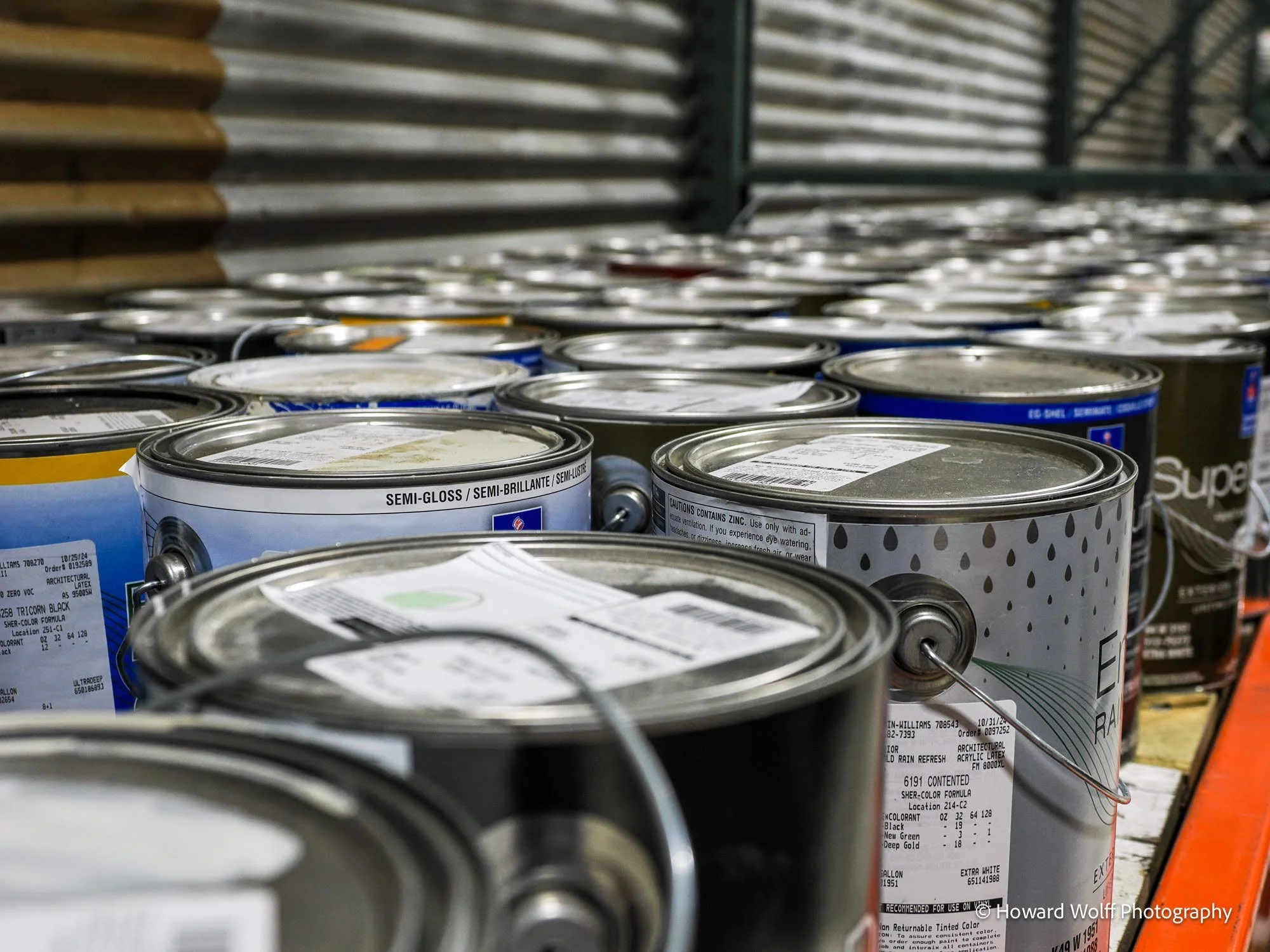 Rows of mistints of paint cans.