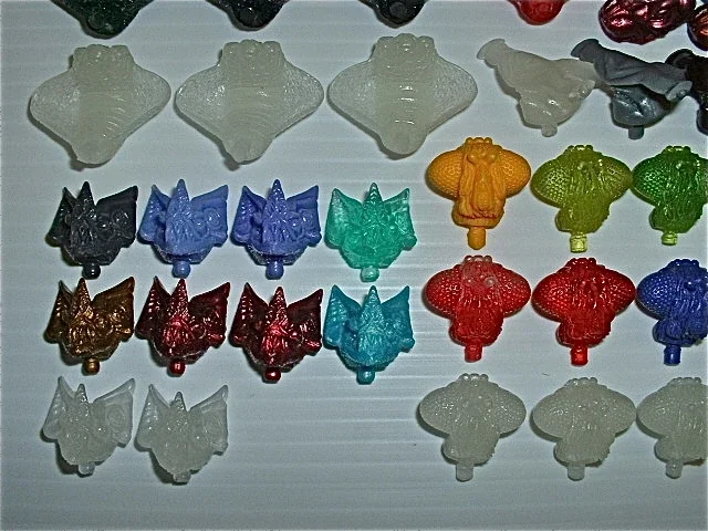 Colorful animal and character-shaped gummy candies arranged in rows.