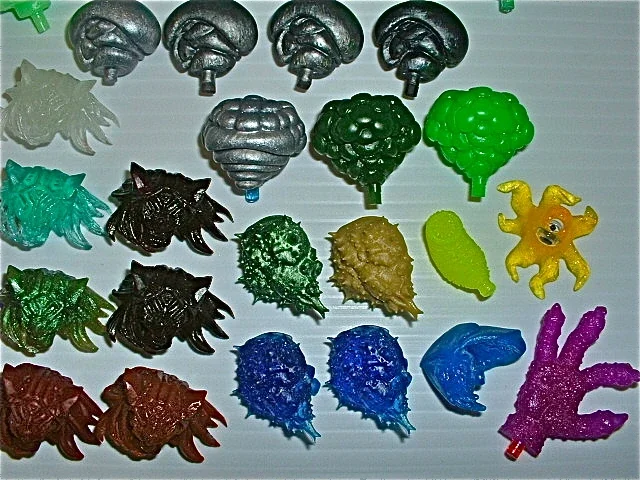 Collection of plastic toy bugs and insects in various colors and shapes.