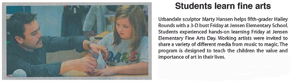 A man demonstrating a 3-D art project to a young girl during a fine arts class at Jensen Elementary School.