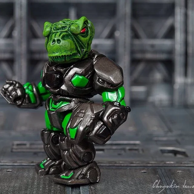 A toy figure of a Hulk character with a dinosaur head, dressed in black and green armor, standing on a textured surface with a gray background.