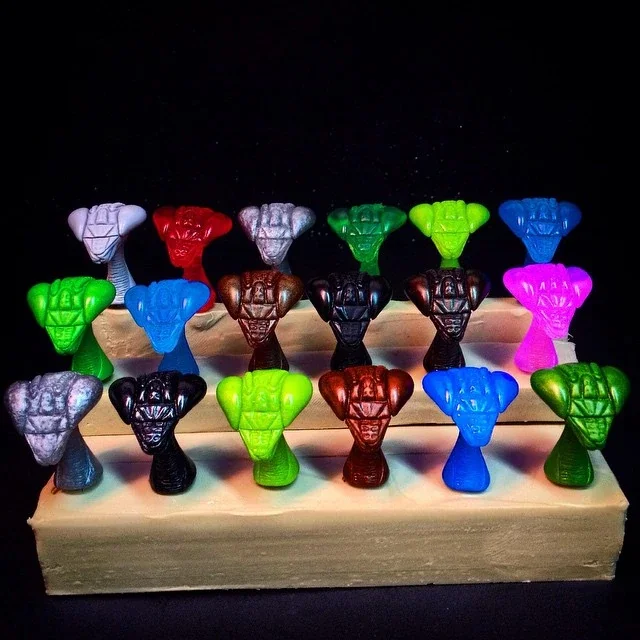 Colorful Star Wars Baby Yoda/Mandalorian character candy chocolates displayed on a tiered wooden stand.