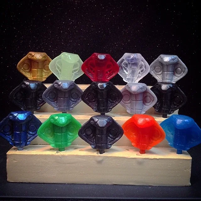 Colorful Tetris-shaped figures displayed on a wooden stand against a starry background.