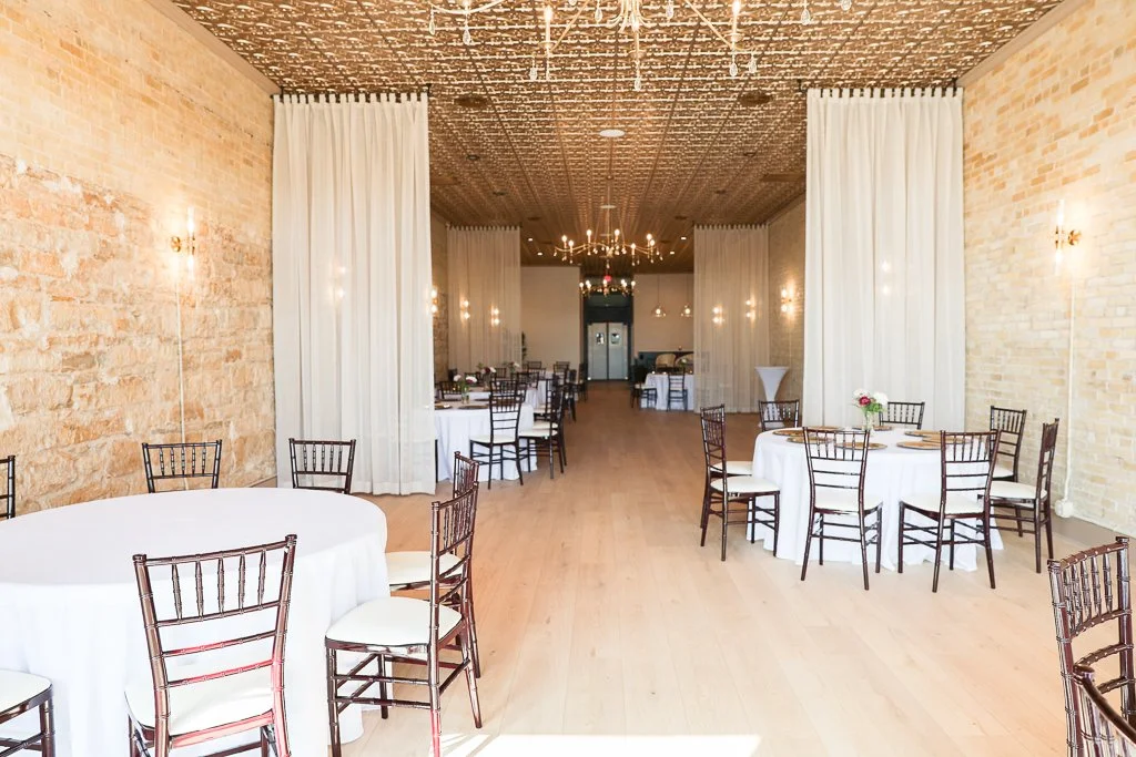 The Venue by Chateau Claire interior view with tables, linens, and chairs, in Hondo, Texas.