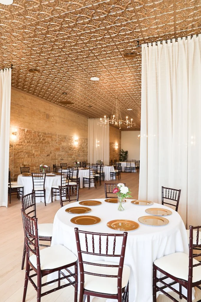 The Venue by Chateau Claire interior view with tables, linens, and chairs, in Hondo, Texas.