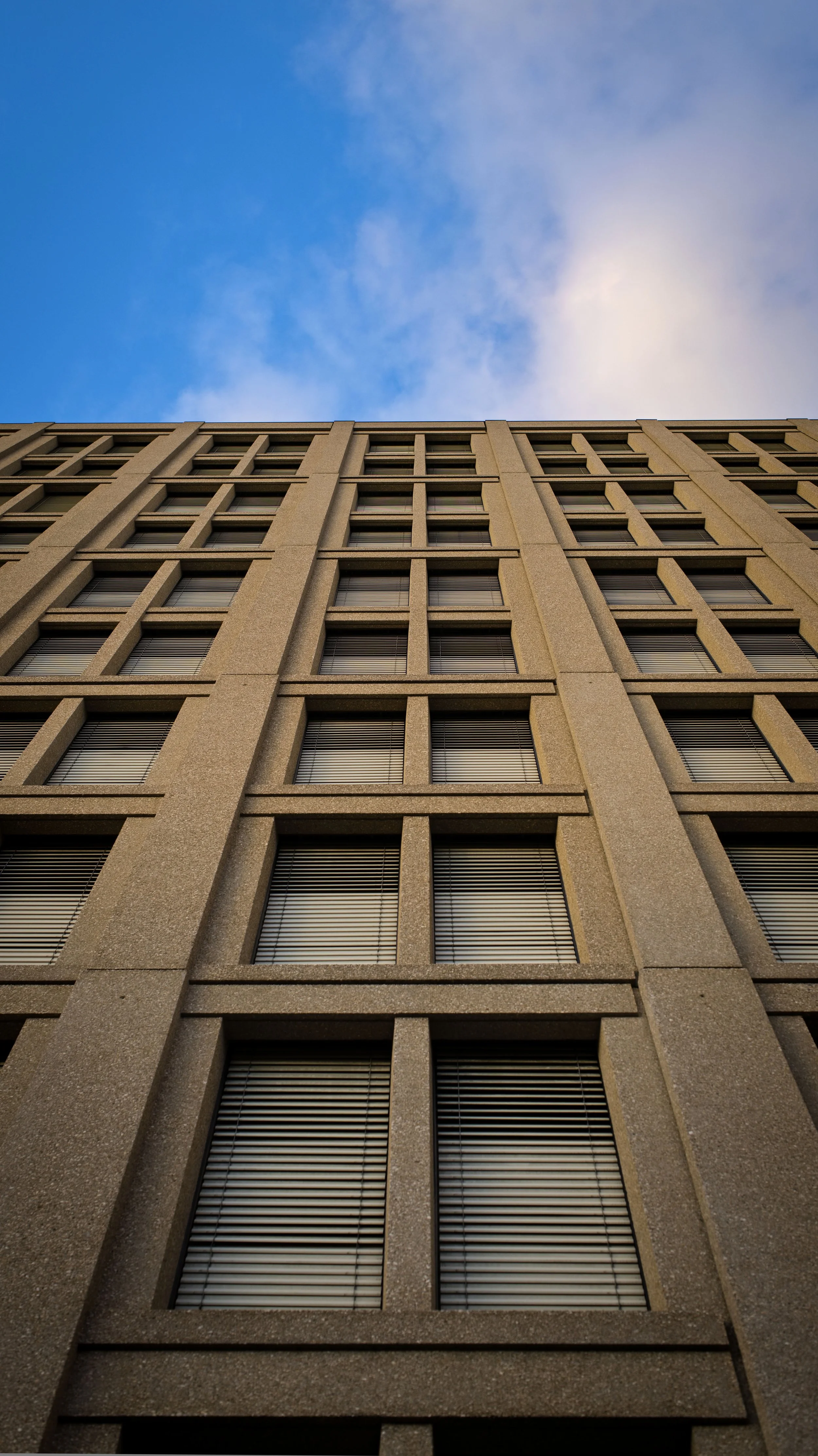 Moderne Gebäudefassade aus der Untersicht mit geometrischen Fenstern