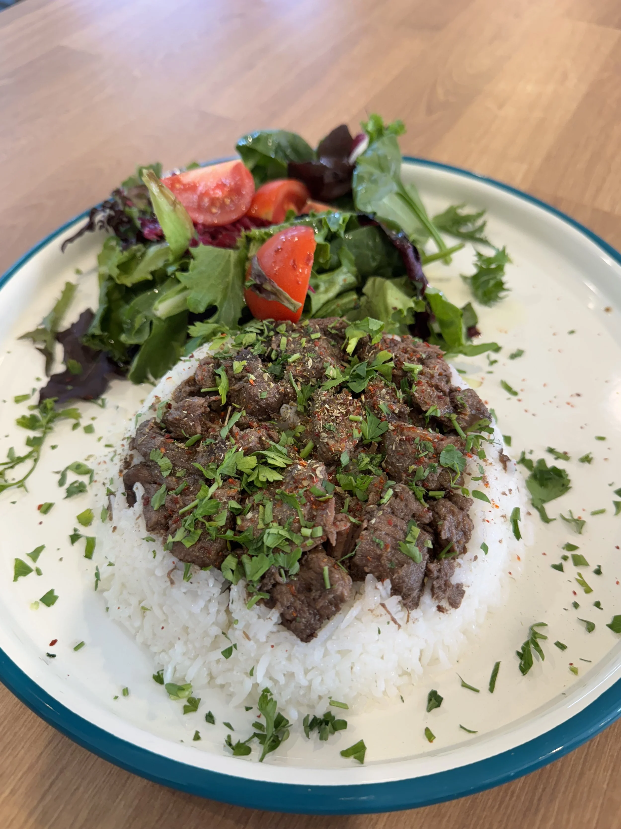 Kavurma plate with slow-cooked lamb, rice and mixed greens at Bernas Turkish Restaurant and Bakery Issaquah