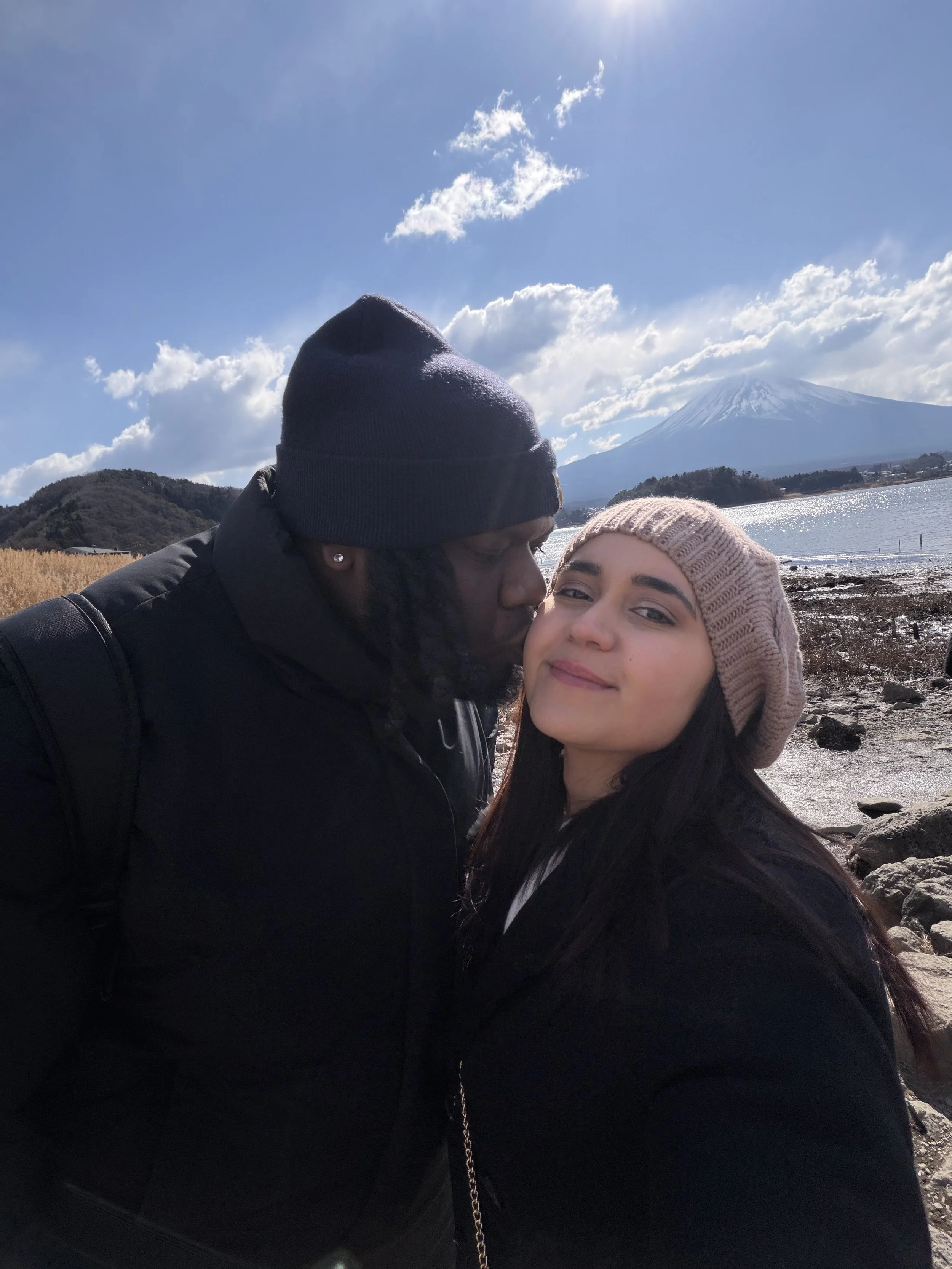 David and his fiancée taking a travel selfie with the snow-capped Mount Fuji in the background in Honshu, Japan.