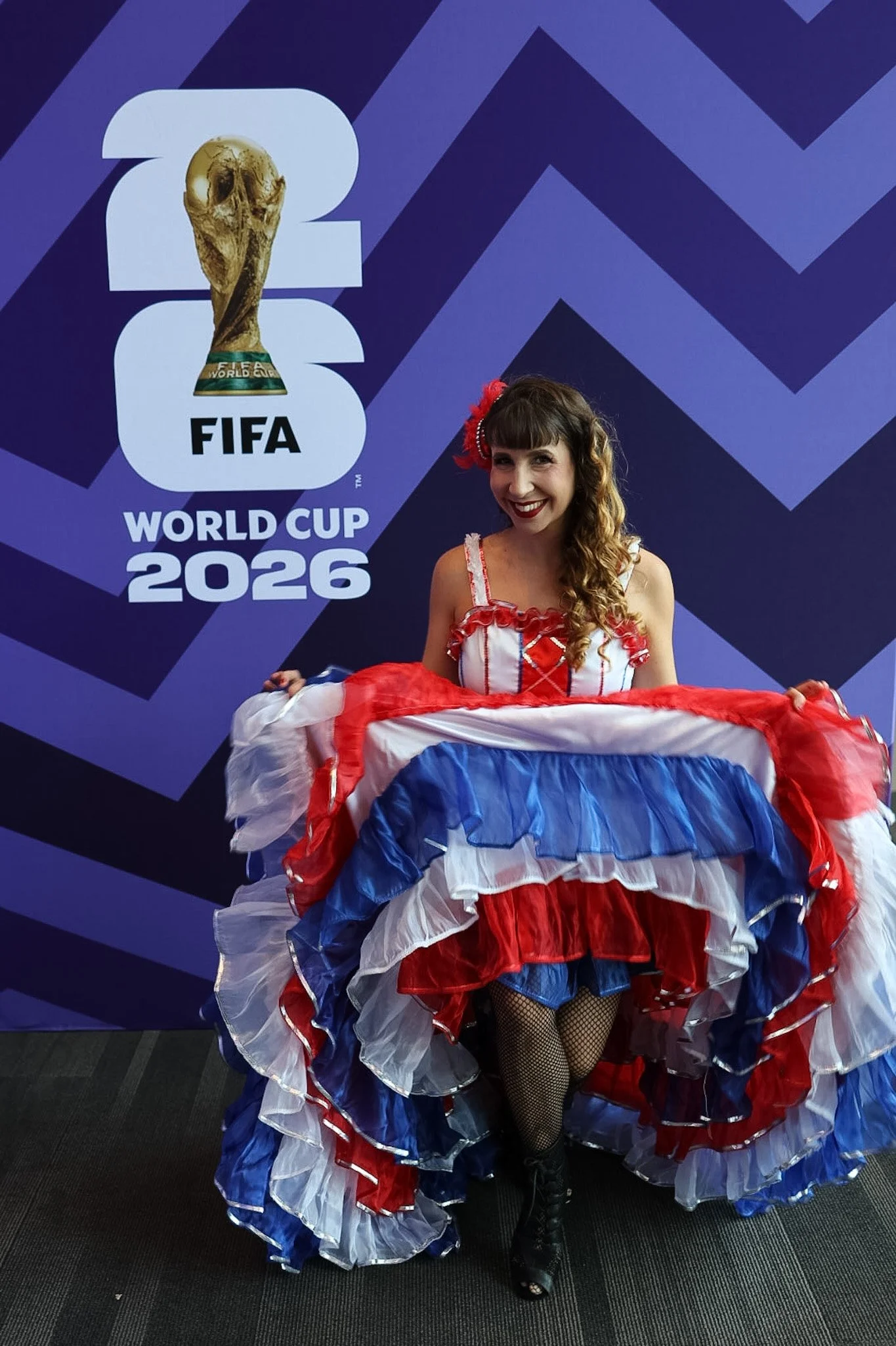 Guest posing in front of the FIFA World Cup 26 trophy display at a brand activation event, nationwide corporate event photography