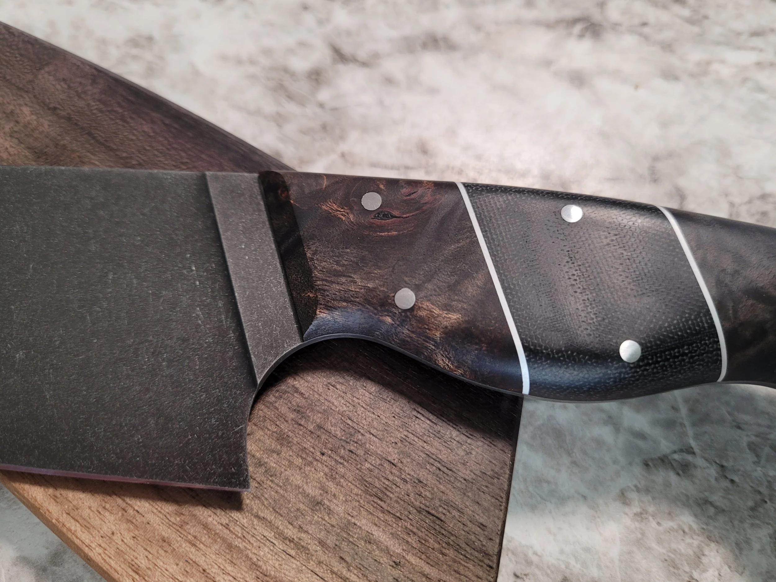 Ebony and black micarta handle.