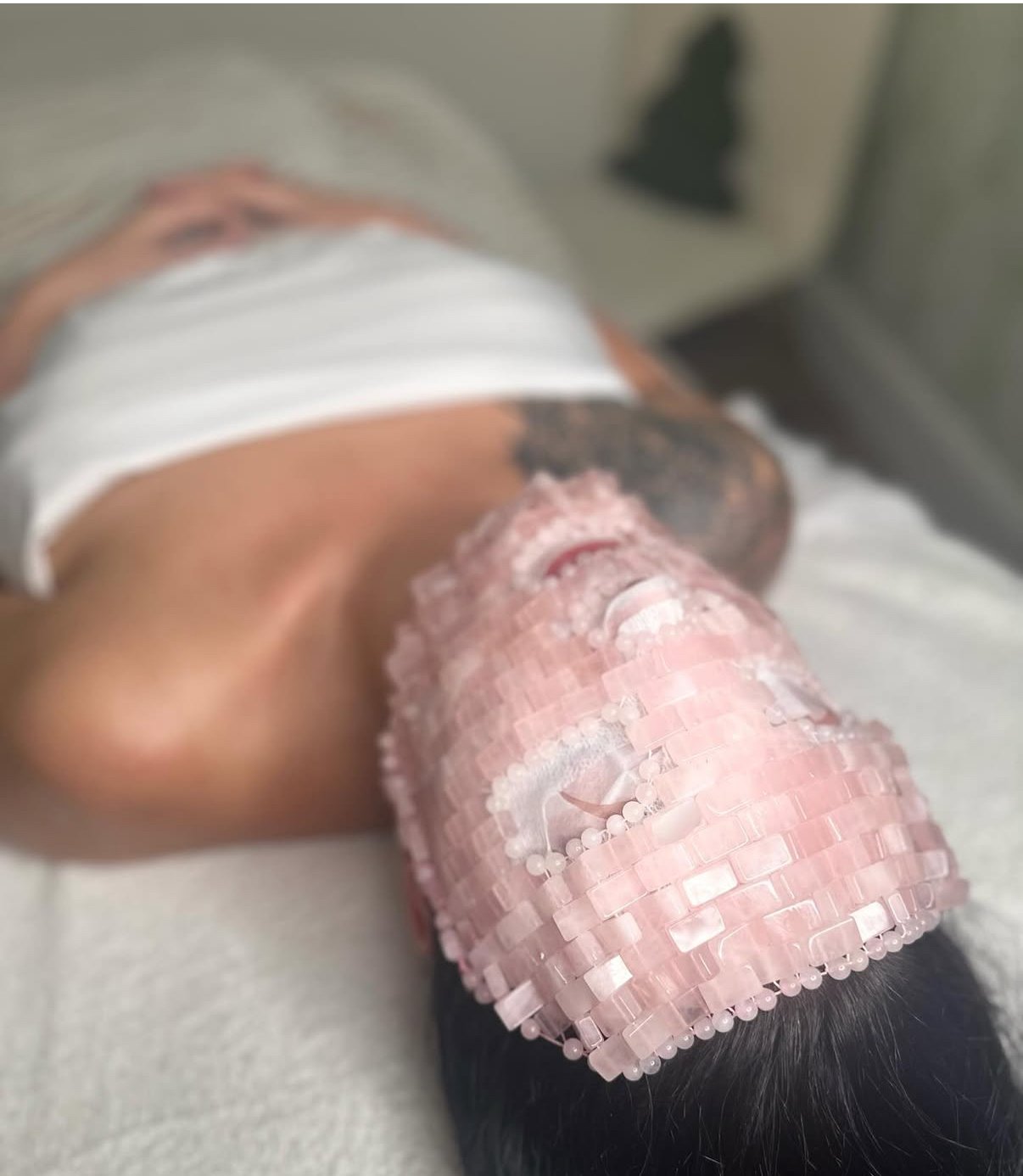 Close-up of a person's forearm with a pink plastic hospital brace or splint, resting on a medical table.