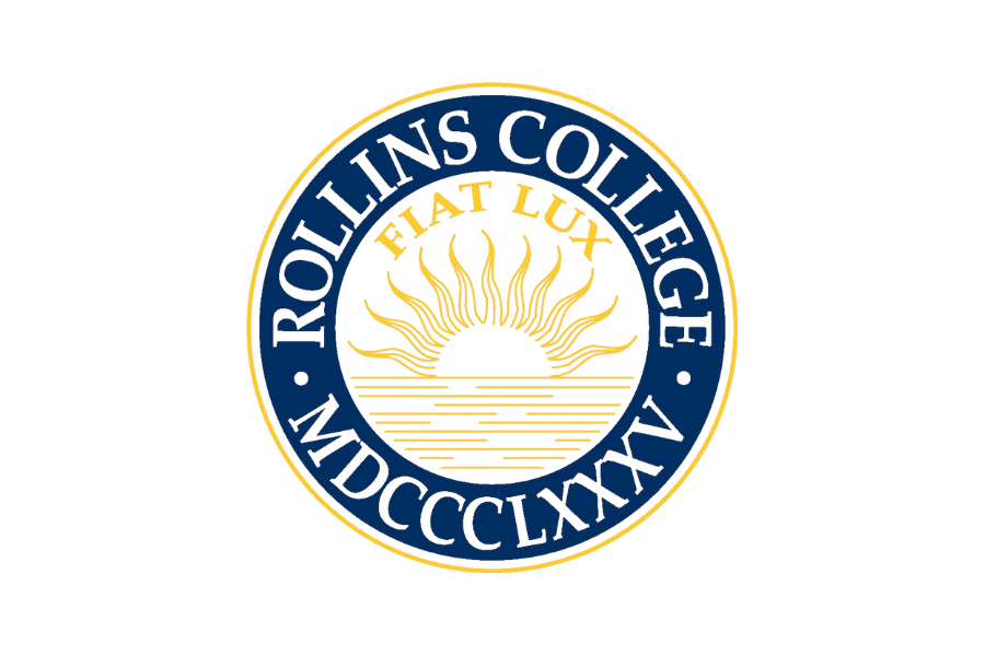 A circular logo for Hollins College, featuring a sunset with rays and water, with the inscription "Hollins College" and Latin abbreviation "MDCCCXLVIII". The banner across the sunset reads "FLAT LUX".