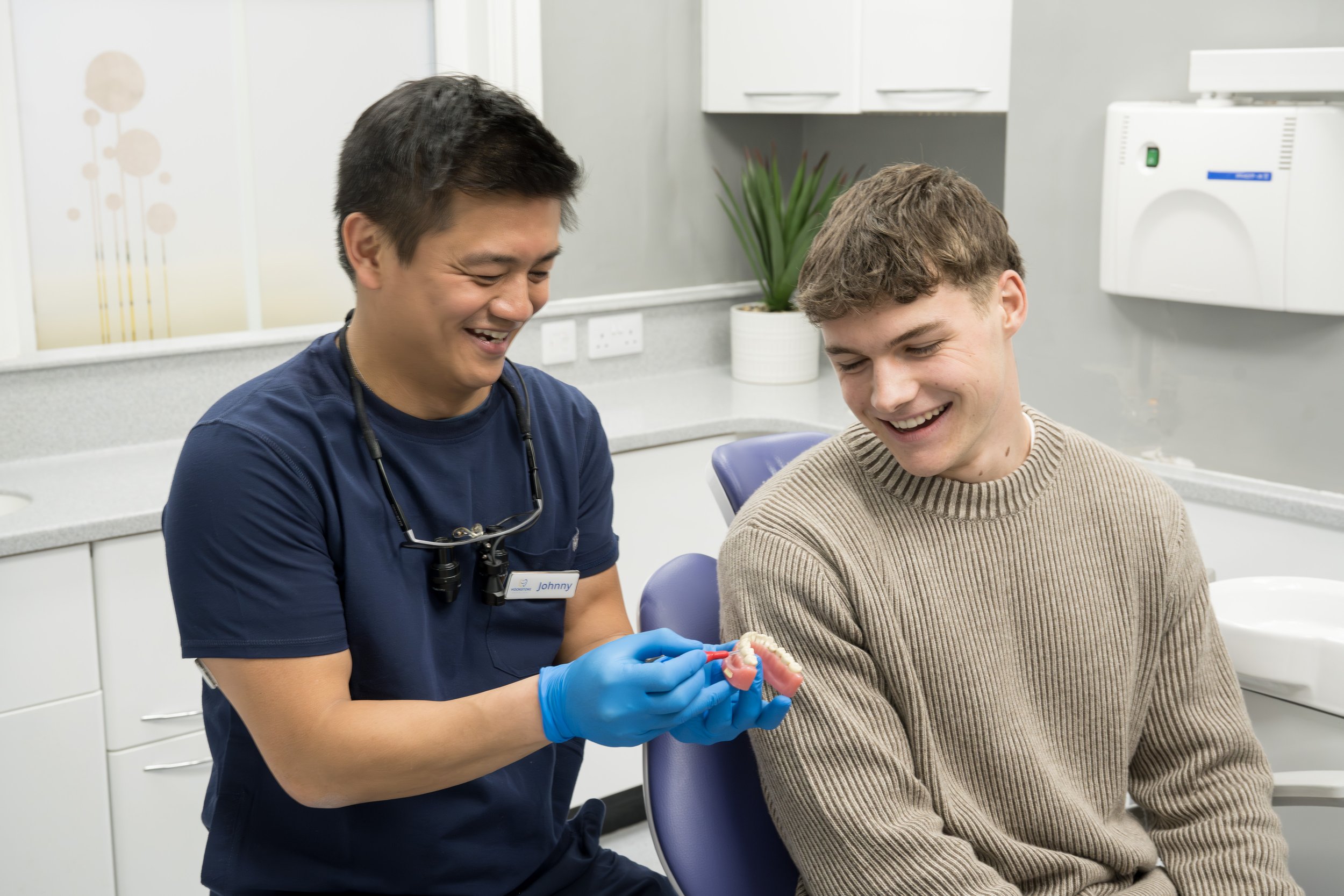 Dentist with a young male patient in a dental clinic at Hookstone Dental in Harrogate