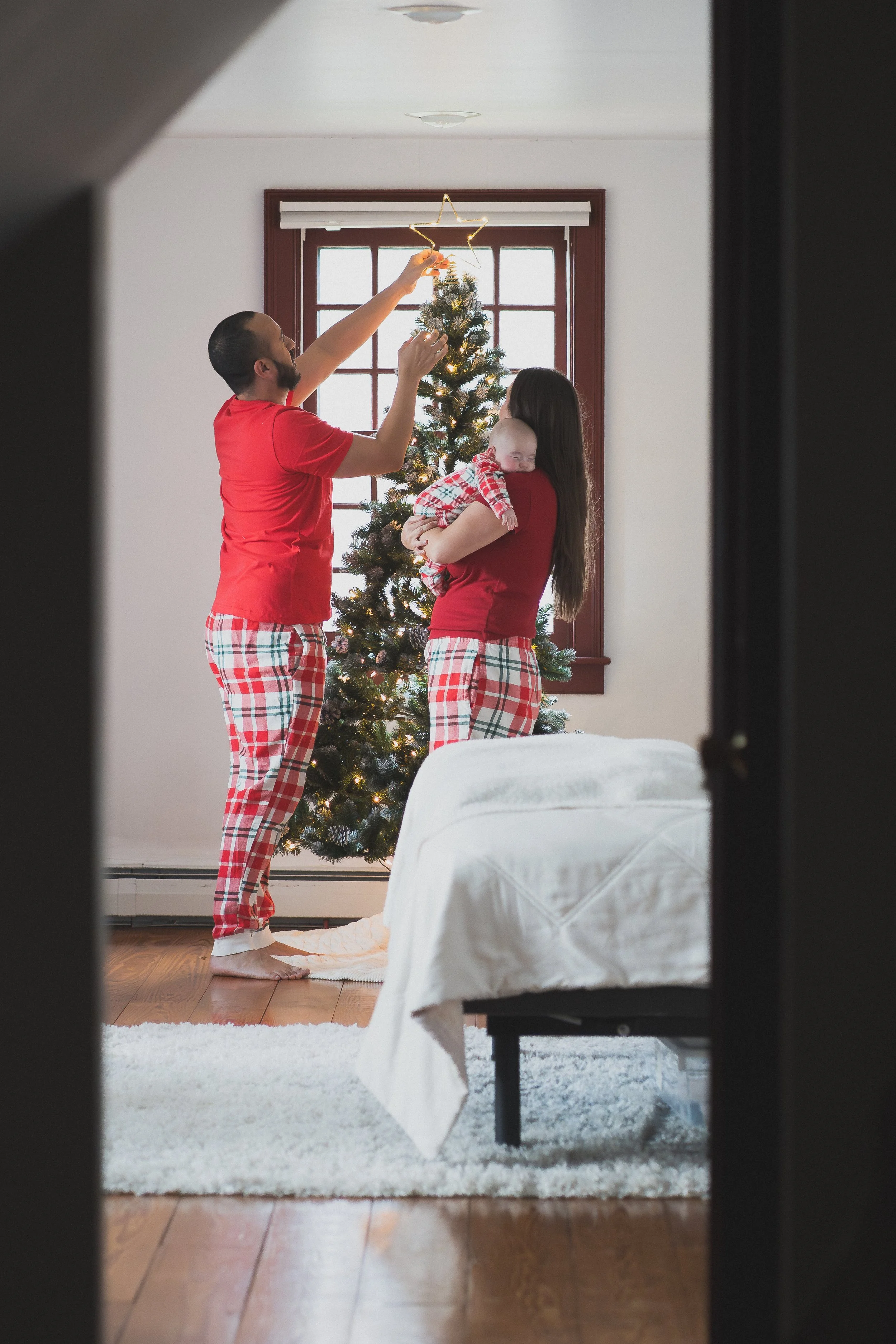 Family decorating their Christmas tree