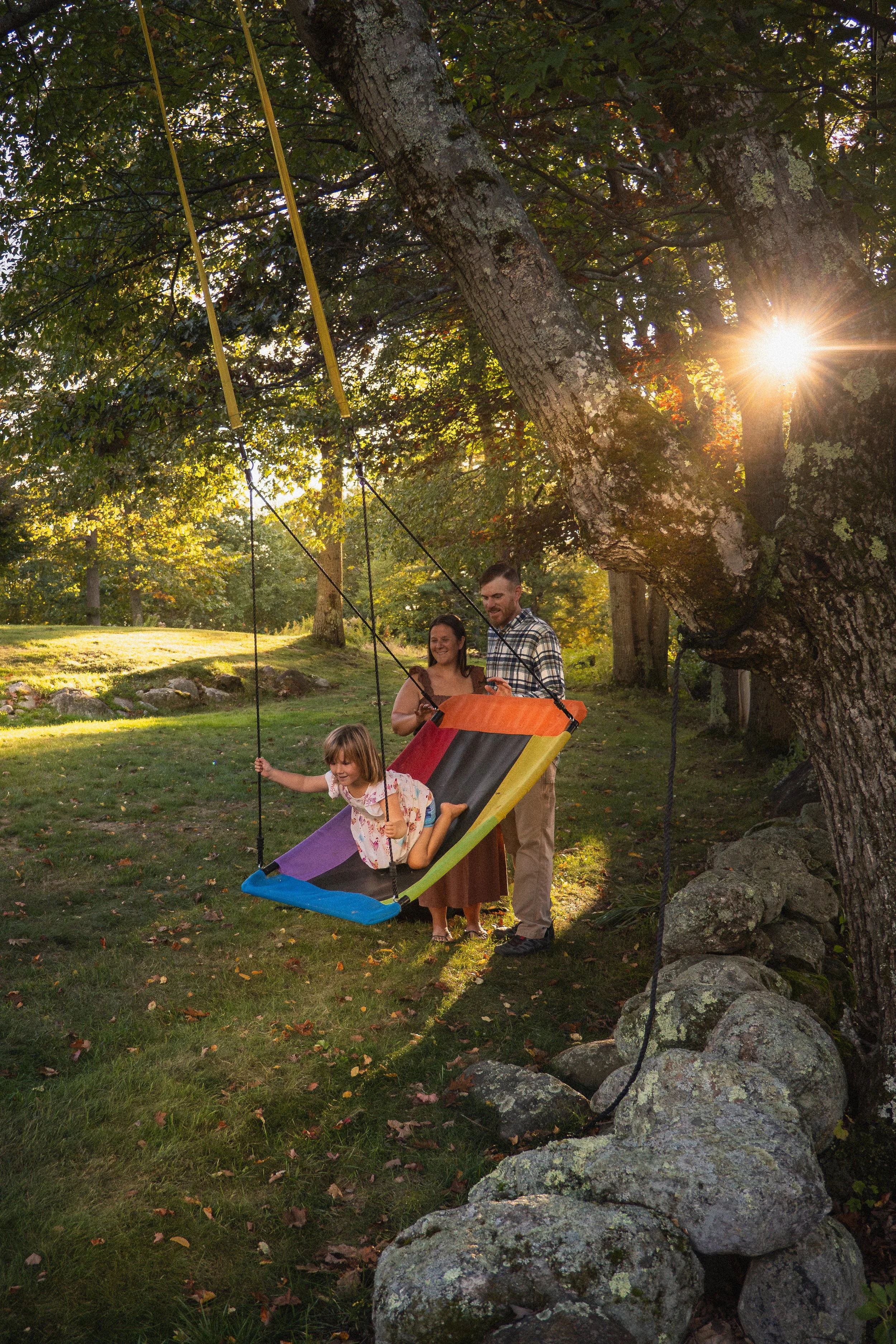 Family enjoying a candid outdoor lifestyle photography session in Central Massachusetts during golden hour