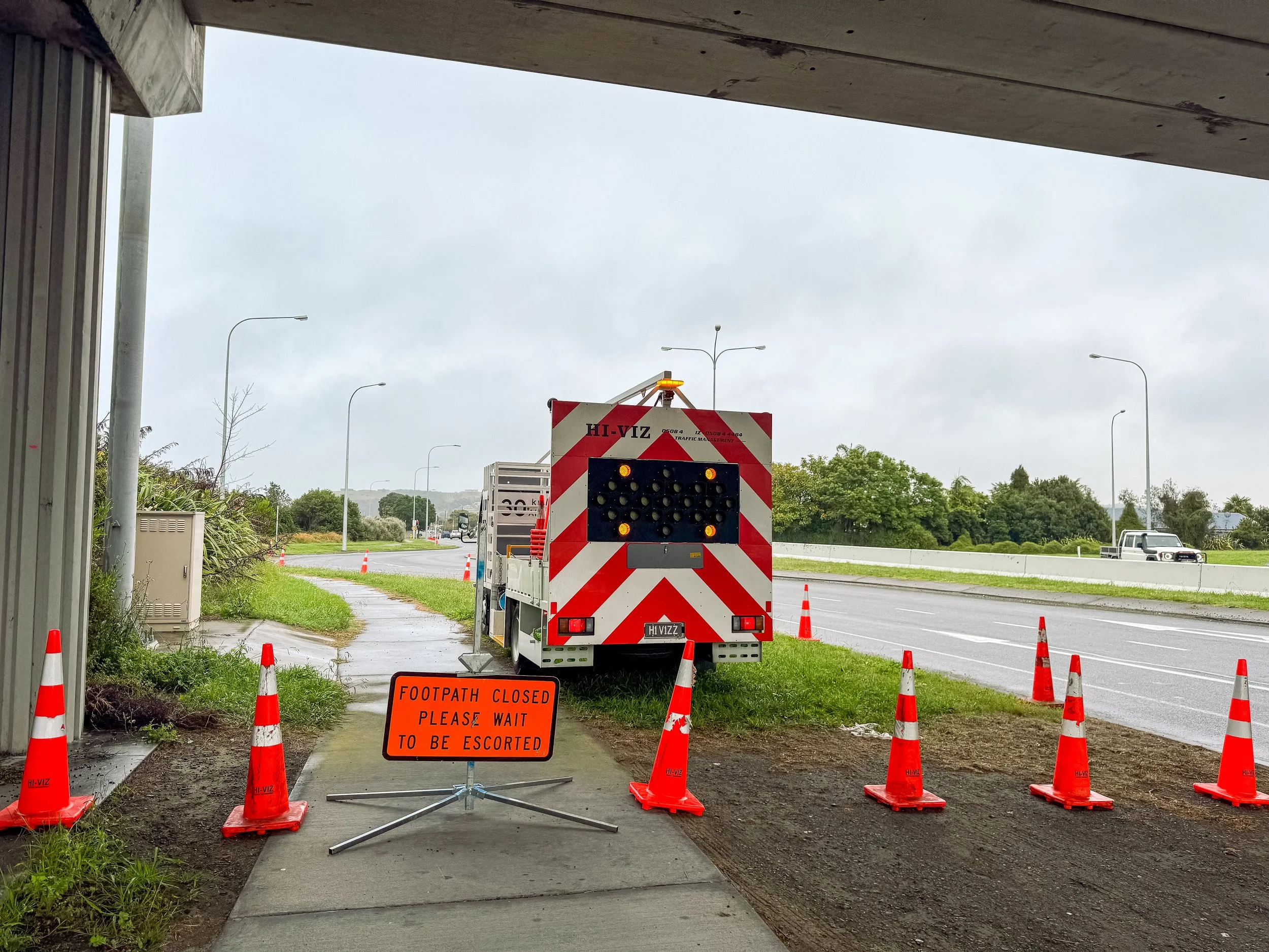 Hi-Viz TTM footpath closure under the Napier expressway bridge. TTM truck displaying caution on the backboard