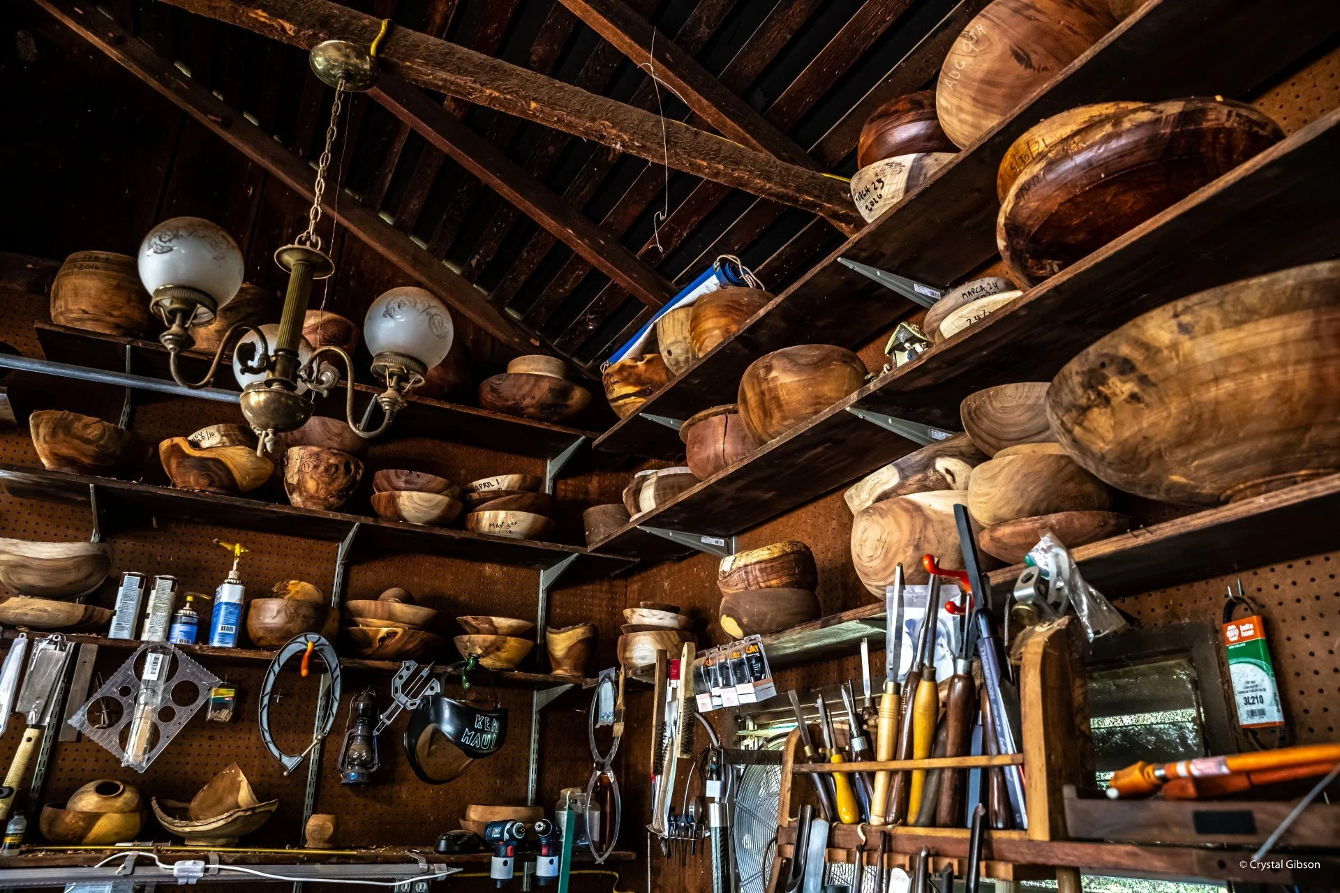 view of Emiliano Achaval Woodturner's shop located in maui, Hawaii. Koa and milo native hawaiian wood bowls in shelves