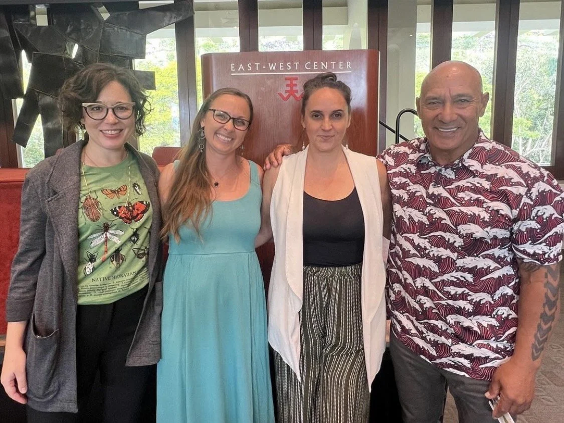Four people smiling at the camera