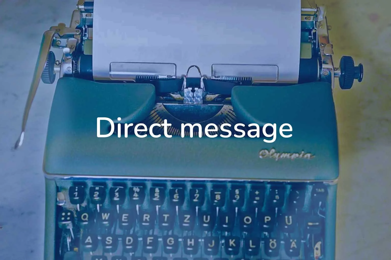 A typewriter loaded with a sheet of paper stands ready to type your message.