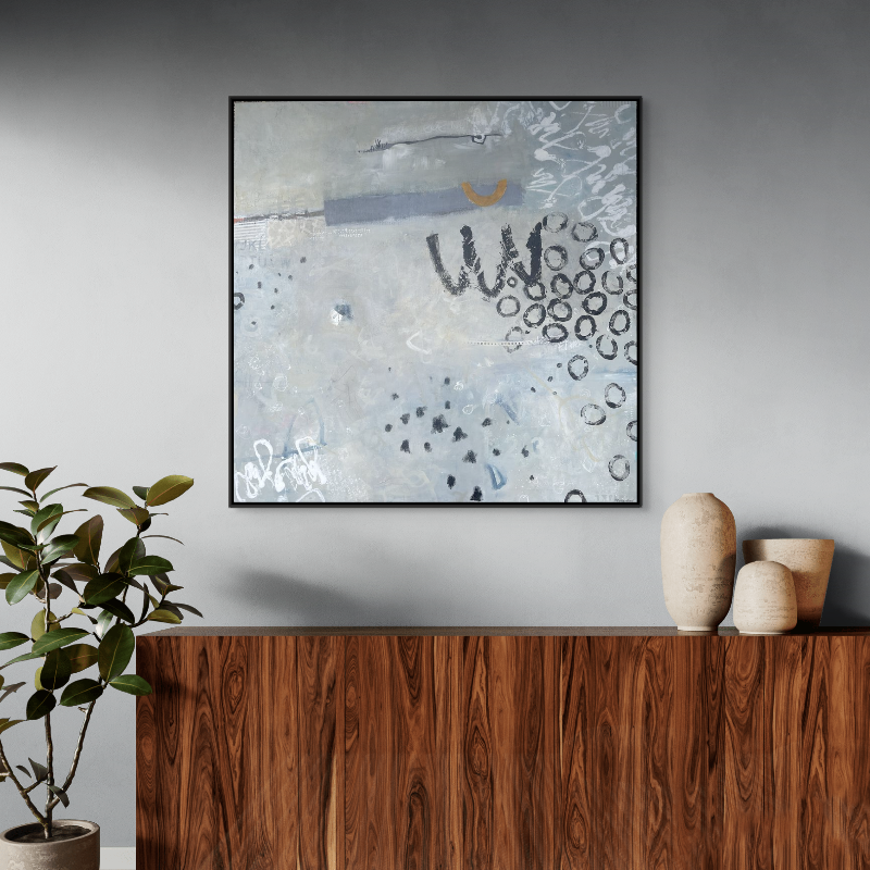 Abstract artwork featuring various shapes, scribbles, and circles in muted tones hanging above a wooden sideboard with three ceramic vases, and a potted plant to the left against a gray wall.