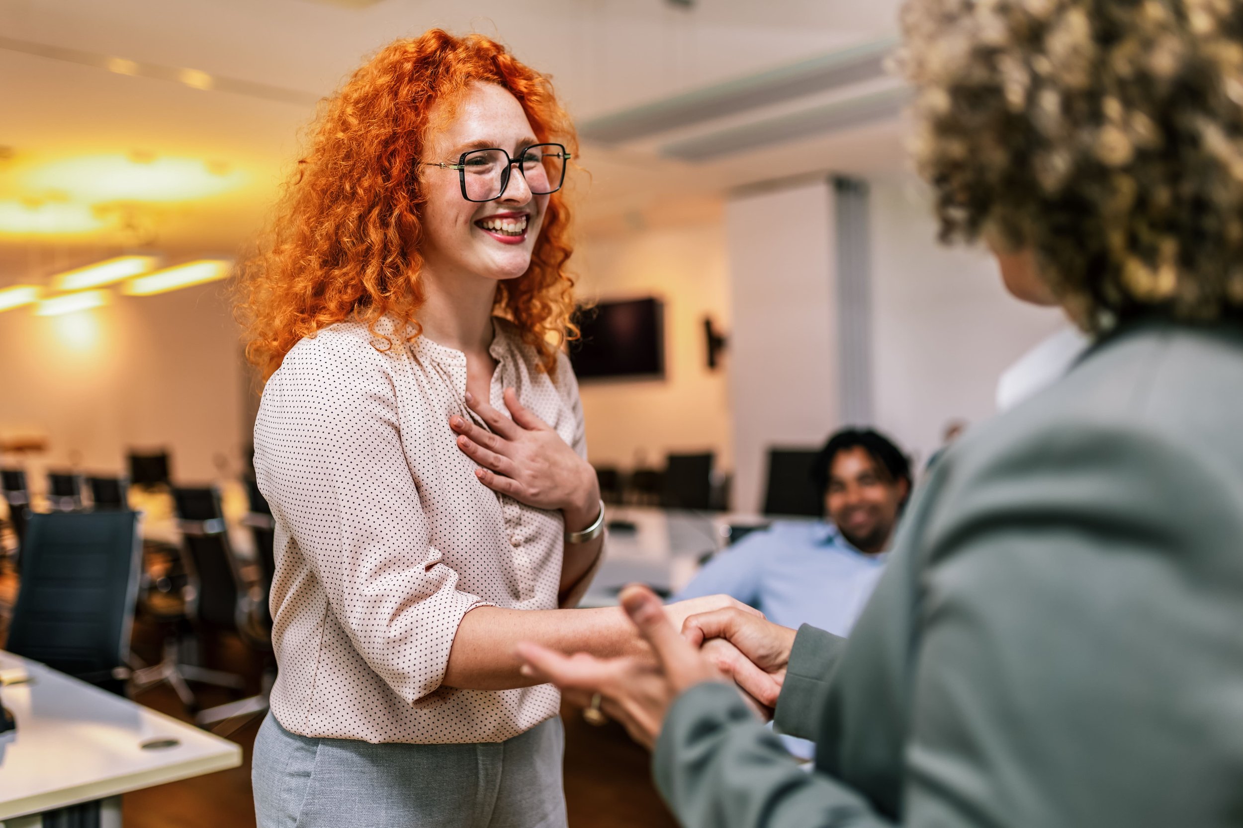 two women shaking hands