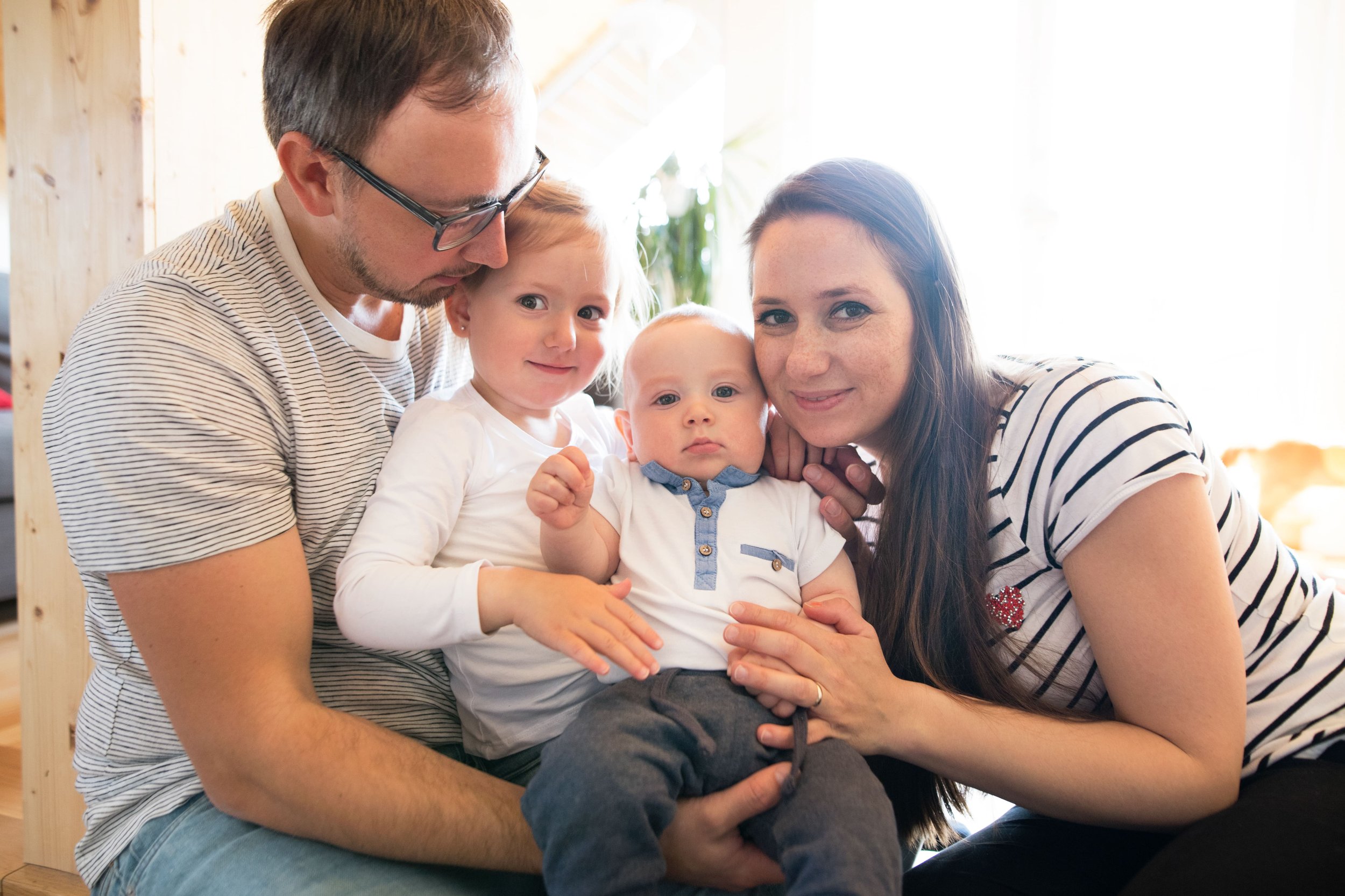 two young children and parents sitting together