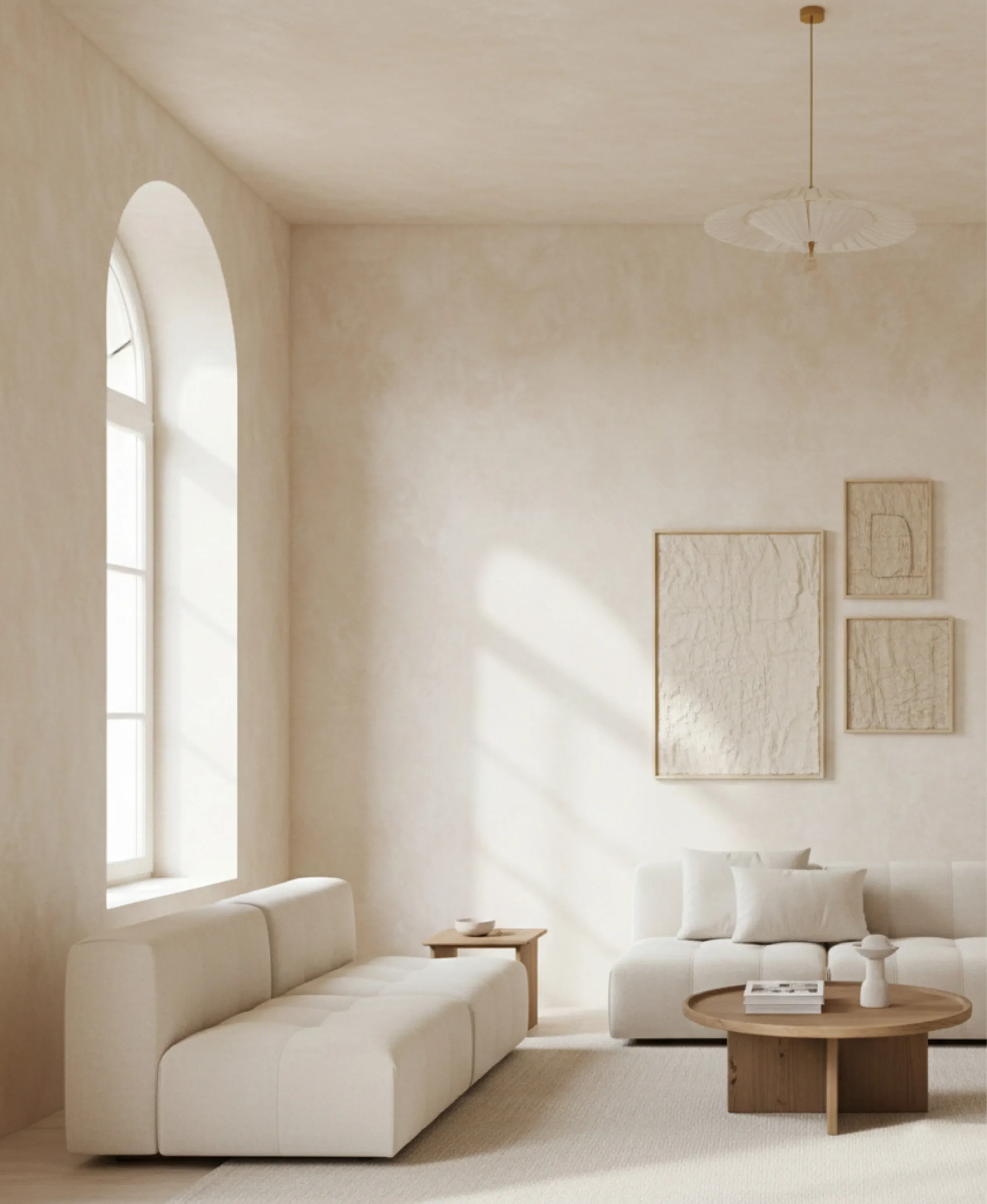 Modern minimalist living room in Los Angeles featuring textured beige Venetian plaster walls, a large arched window, and a modular cream sofa.