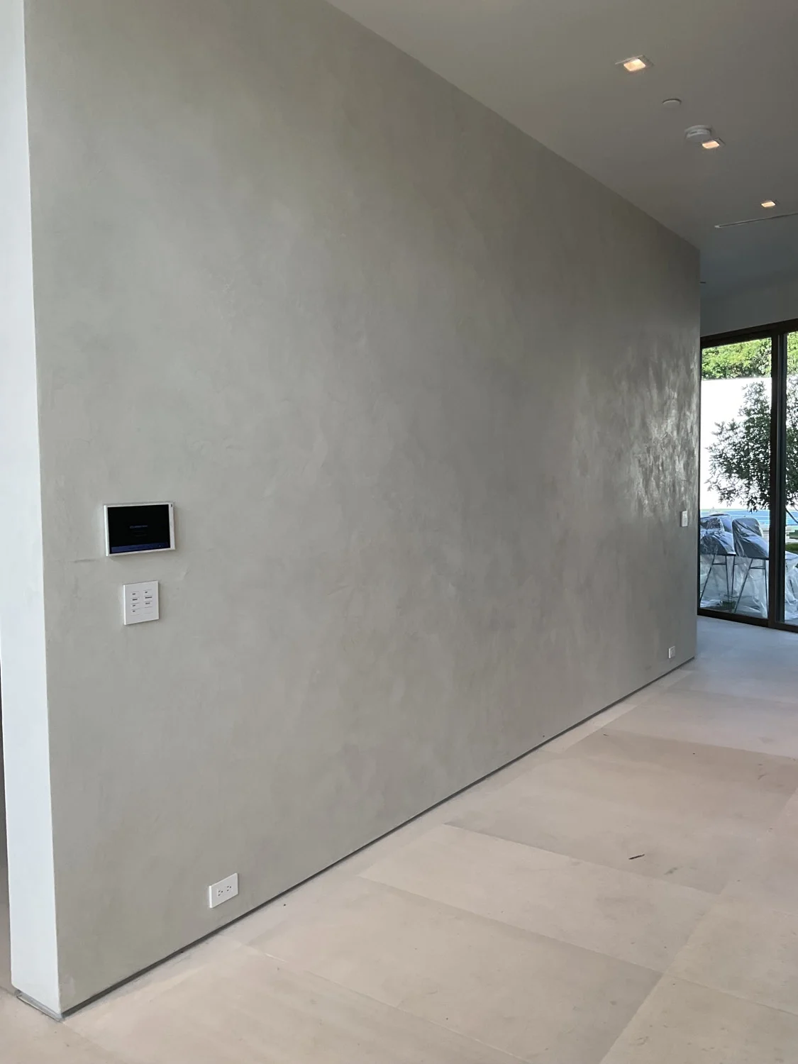 Artisan grey Venetian plaster hallway in the private Beverly Hills residence of developer Richard Heyman.