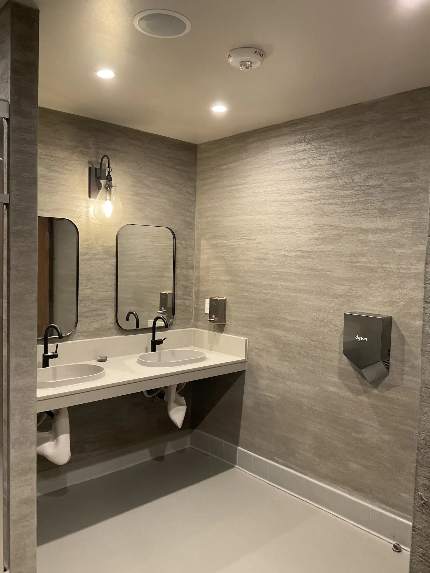 commercial-restroom-grey-textured-venetian-plaster.webp