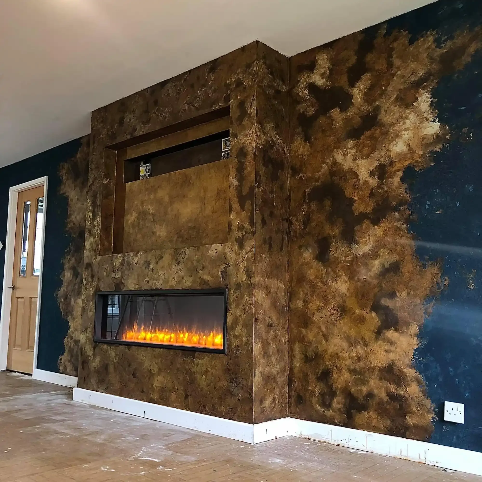 bronze-mottled-textured-venetian-plaster-fireplace.webp