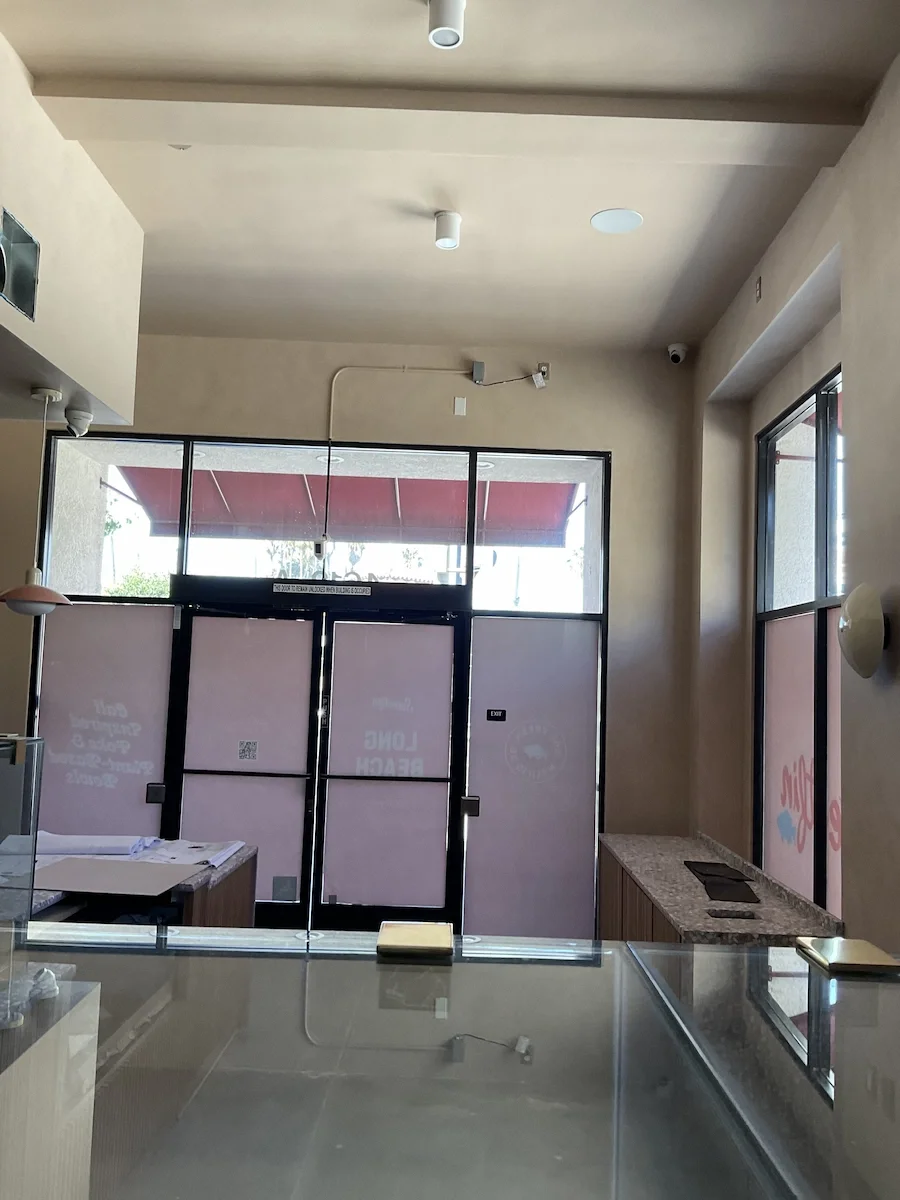 Seamless warm beige Venetian plaster interior walls and ceiling in the Sweetfin Long Beach restaurant storefront.