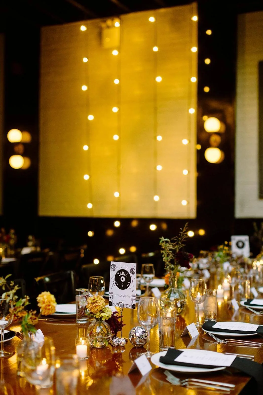 Event table set with flowers and candles, illustrating client work by Carolyn Yoo.