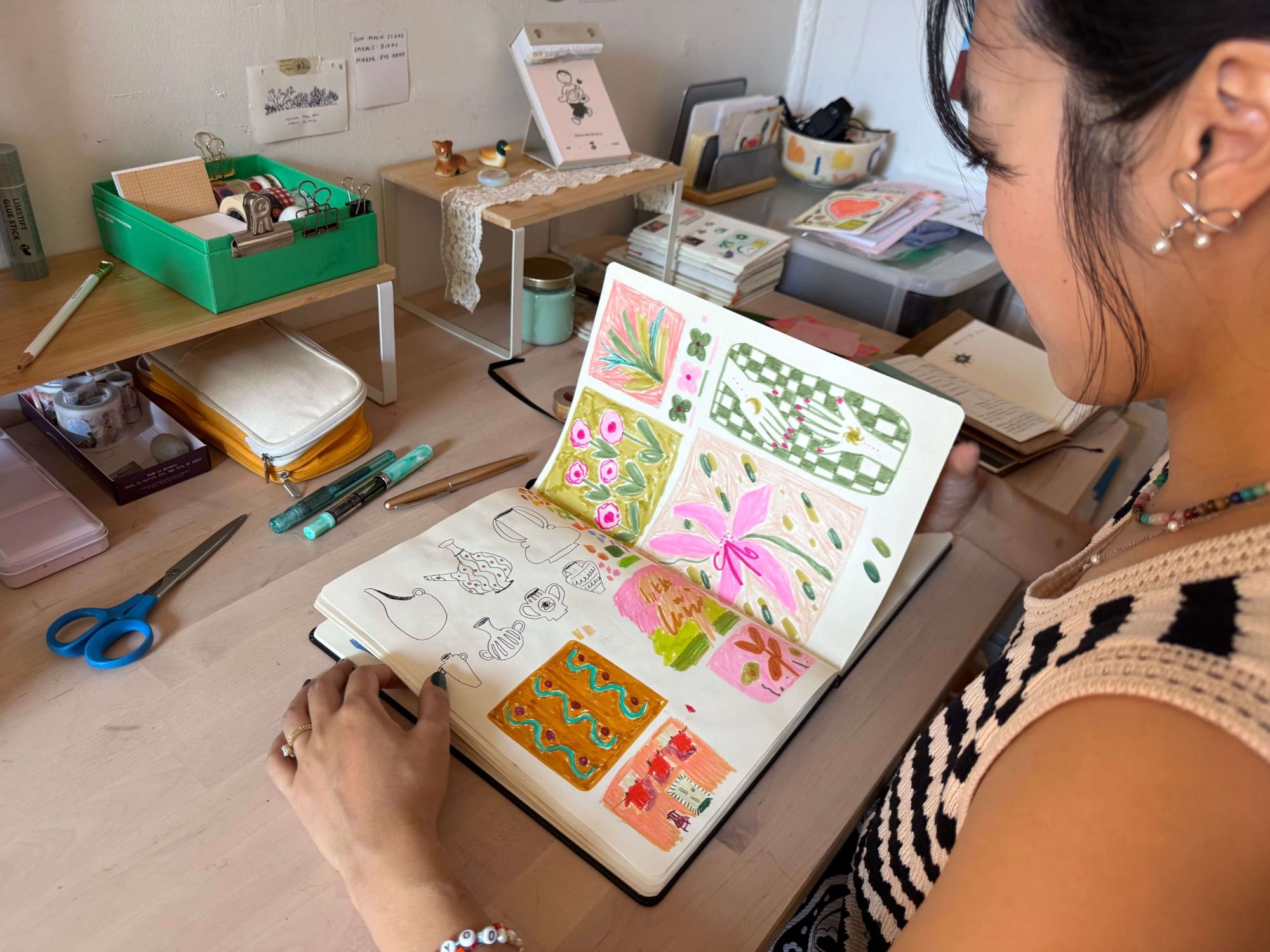 Carolyn Yoo working in her sketchbook during a journaling and sketchbook workshop.