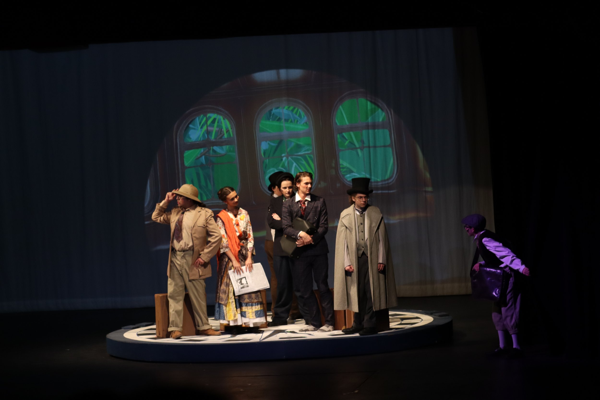 Fogg and Passepartout are angry at Newsboy