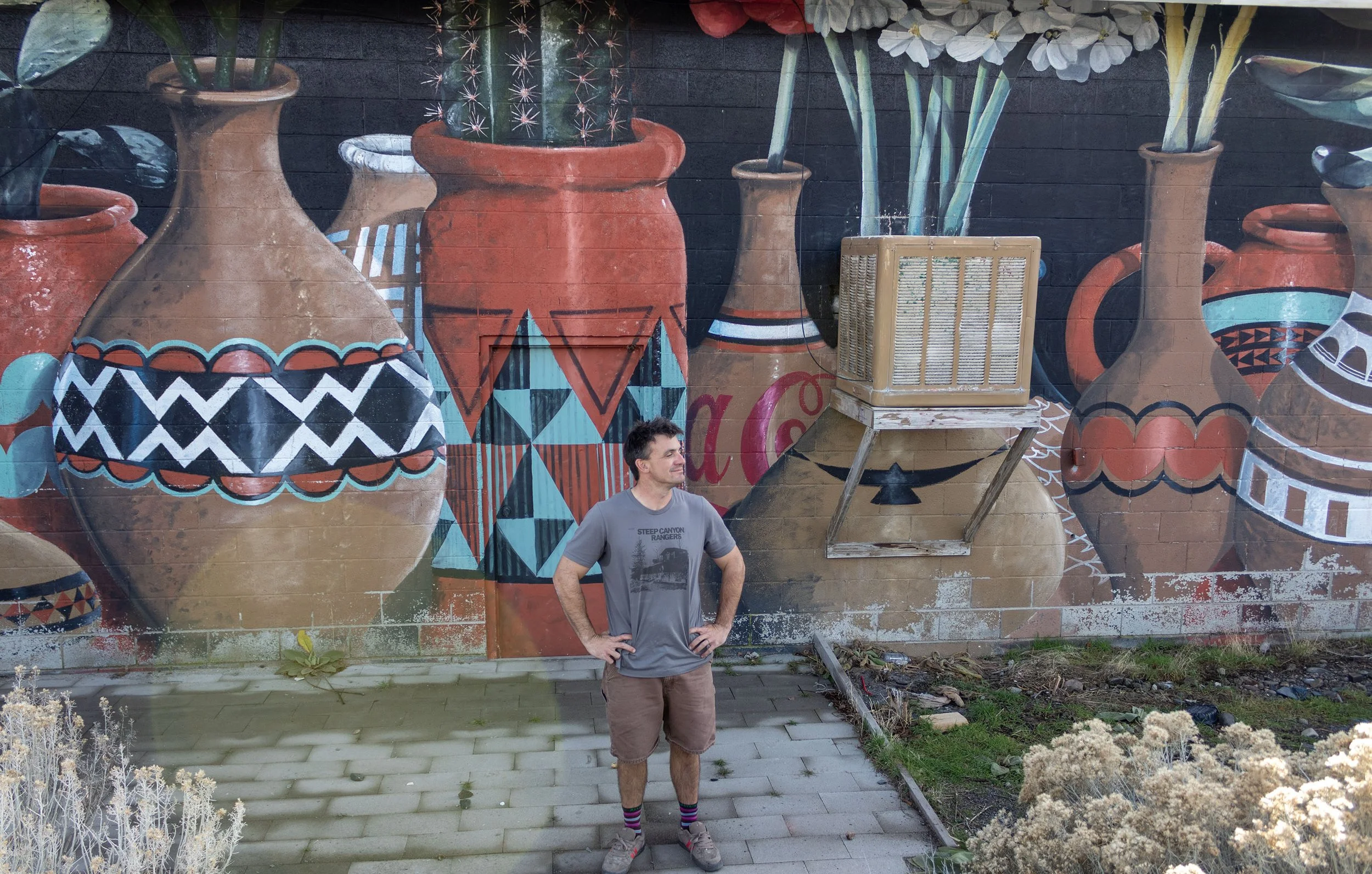 Sutter Stremmel stands behind The Wedge Studio on Dickerson Road in Reno, Nev., facing the train tracks on the hill above, on Sunday, Dec. 7, 2025. Stremmel often finds human waste behind the studio, he has asked members to stay out of the area becau