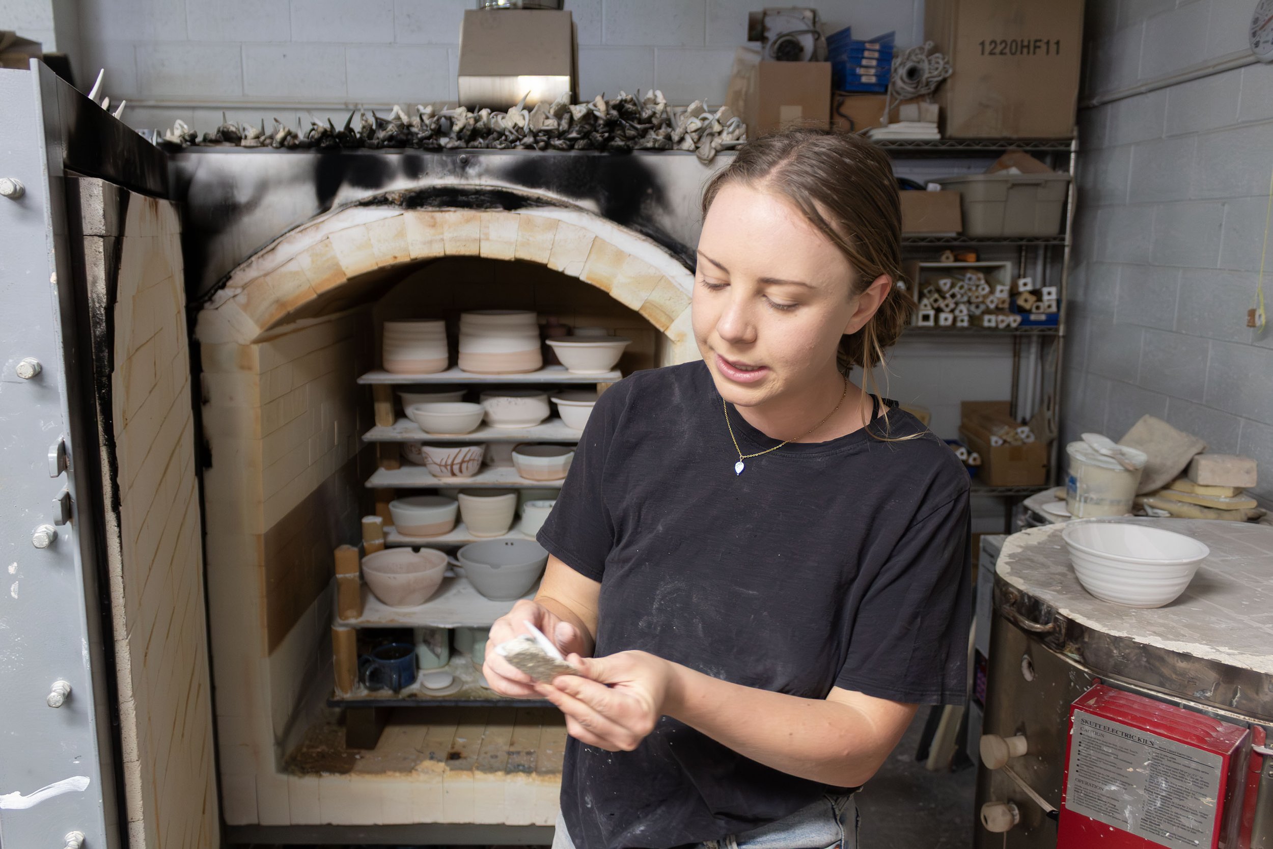 Alicia, 24, a member and instructor at The Wedge Studio, positions pyrometric cones inside a gas-powered kiln at the studio in Reno, Nev., on Saturday, Nov. 15, 2025. Photo by Amanda Avilla