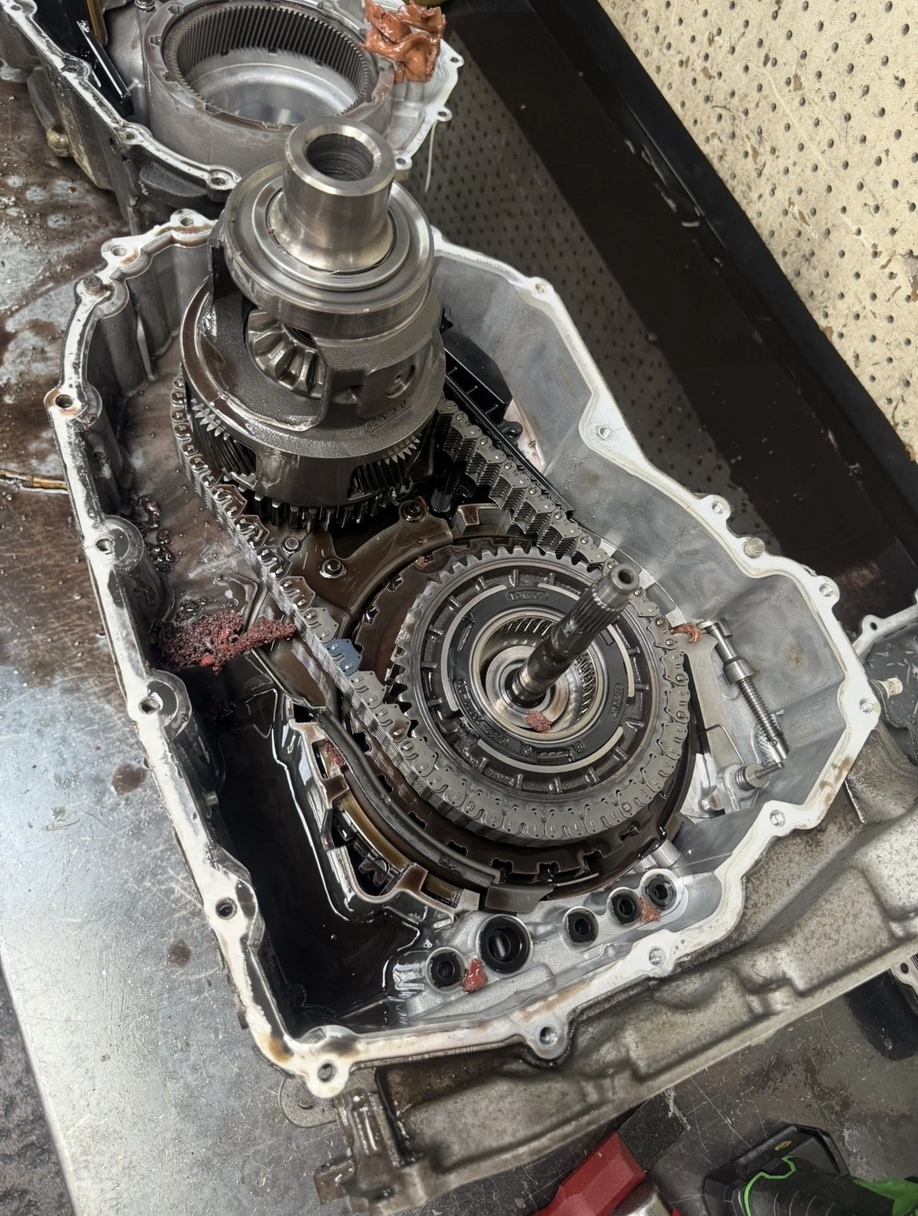 Open car transmission with gears, shafts, and fluid visible inside