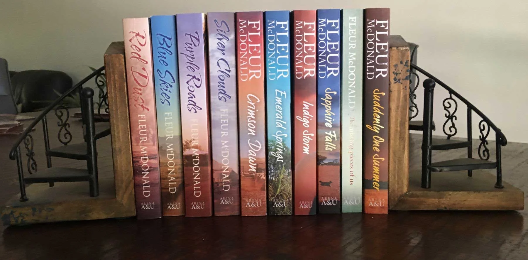 Ten of Fleur's books in-between two book end