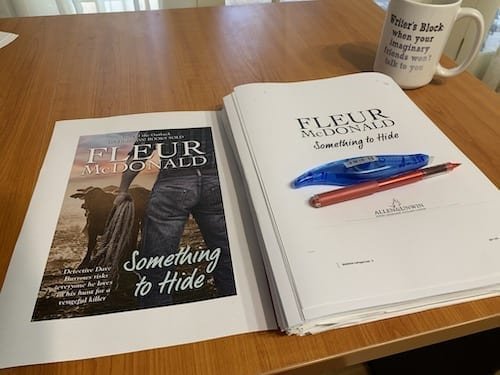 Printed pages of Fleur's book, Something to Hide, on her desk.