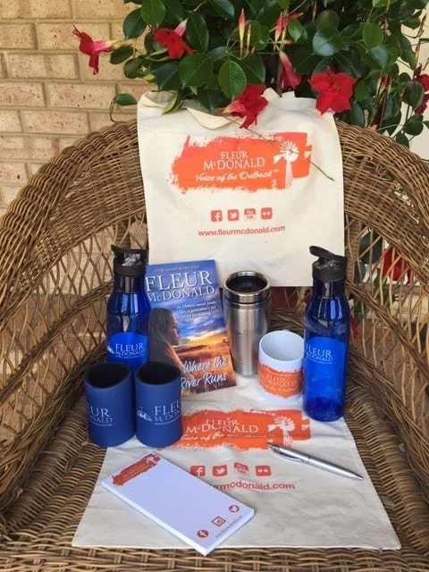 Image of everything in the gift pack listed below laid out on a straw chair