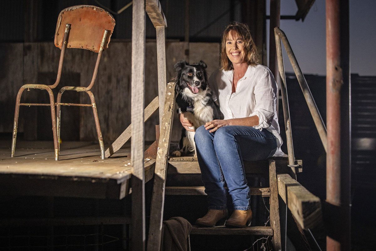 Fleur sits with her beautiful dog Jack on a verandah
