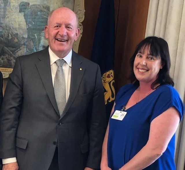 Fleur and the Governor-General standing shoulder to shoulder. He is an older man with a kind face and he is mid laugh here.