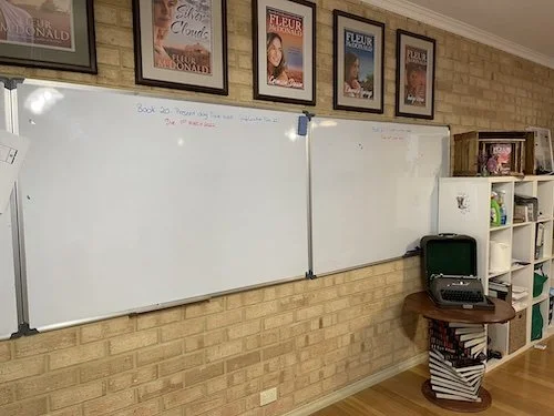 Two white boards reading to be written on
