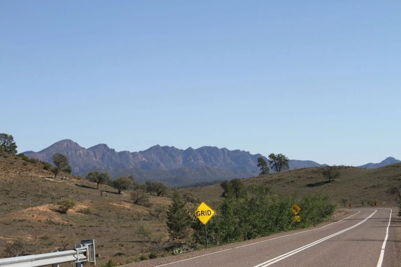 An empty road headed towards mountains