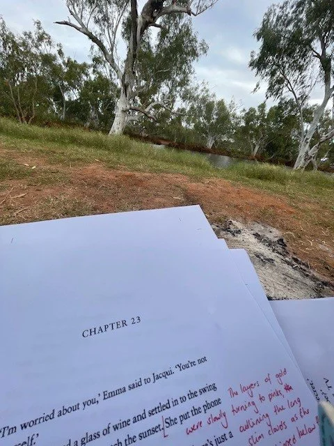 Printed paged of a manuscript with red editing marks.